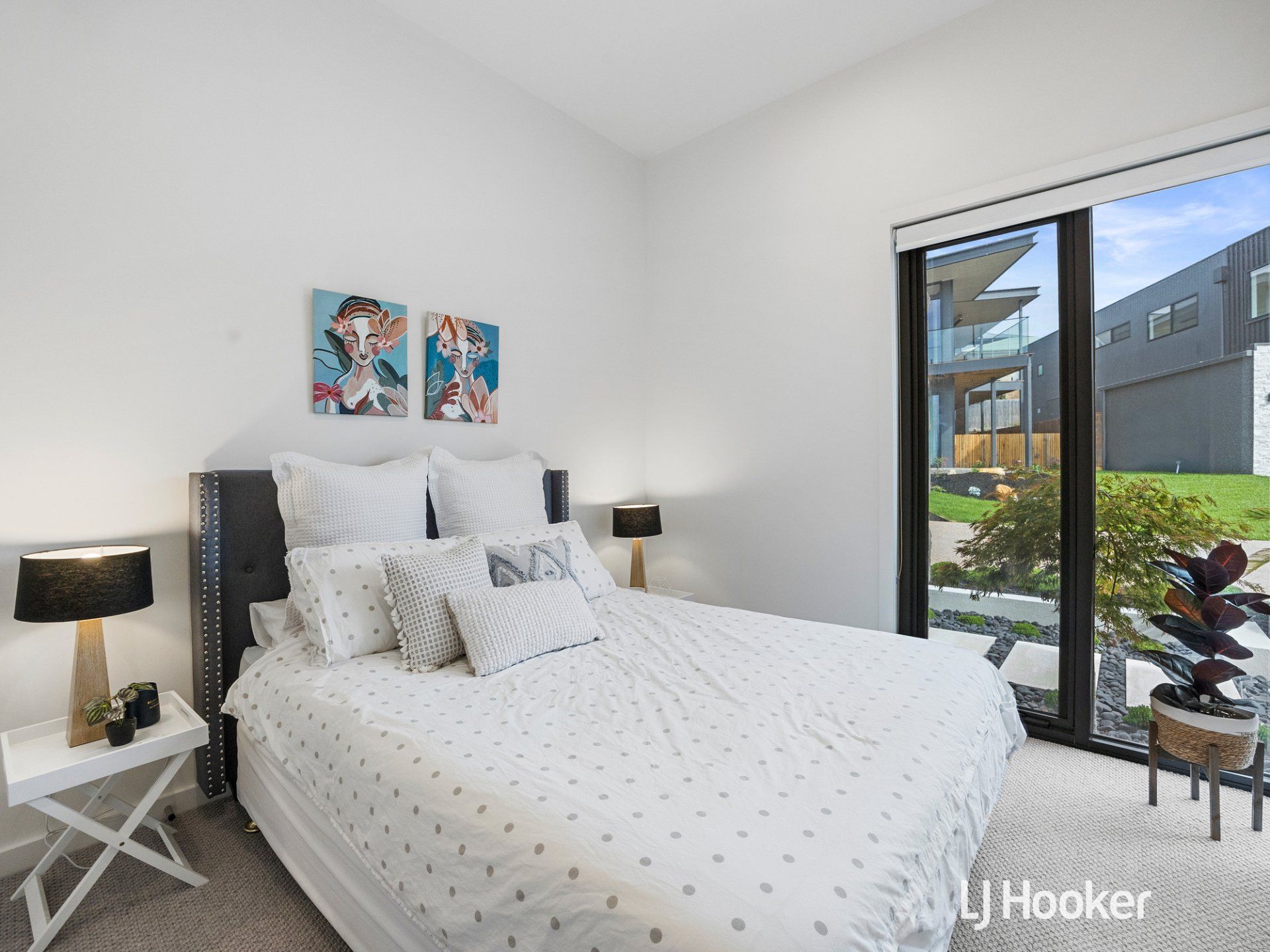 A bedroom with a large bed and a large window