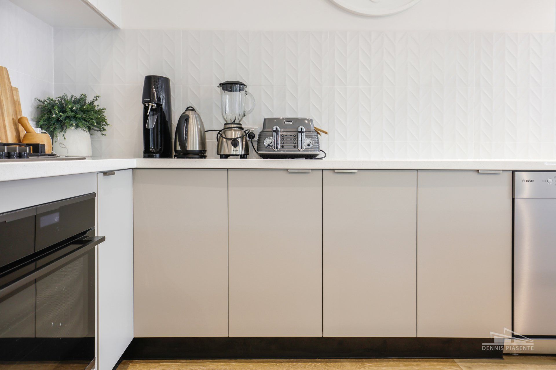 A kitchen with white cabinets and stainless steel appliances.