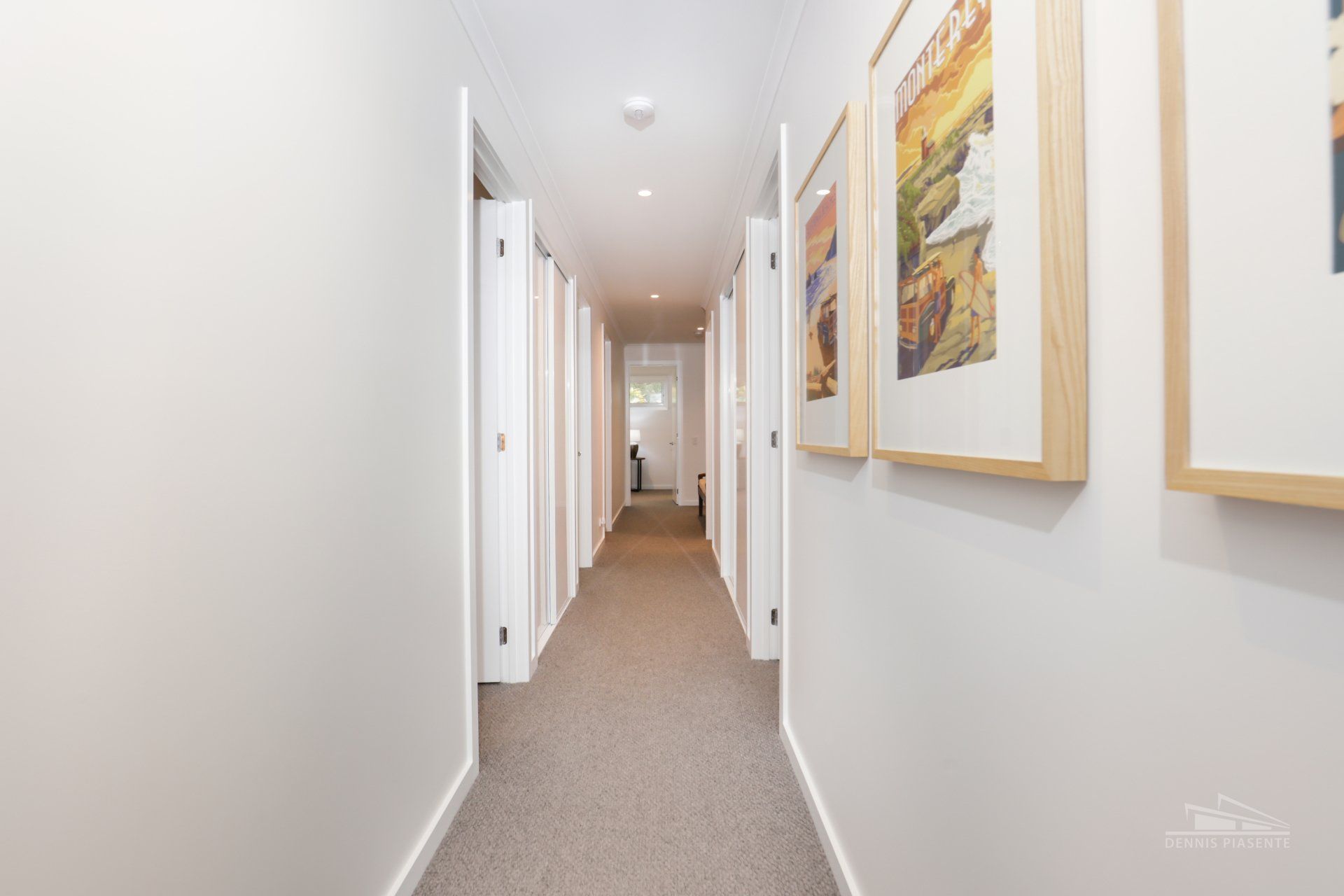 A long hallway with a lot of pictures on the wall.