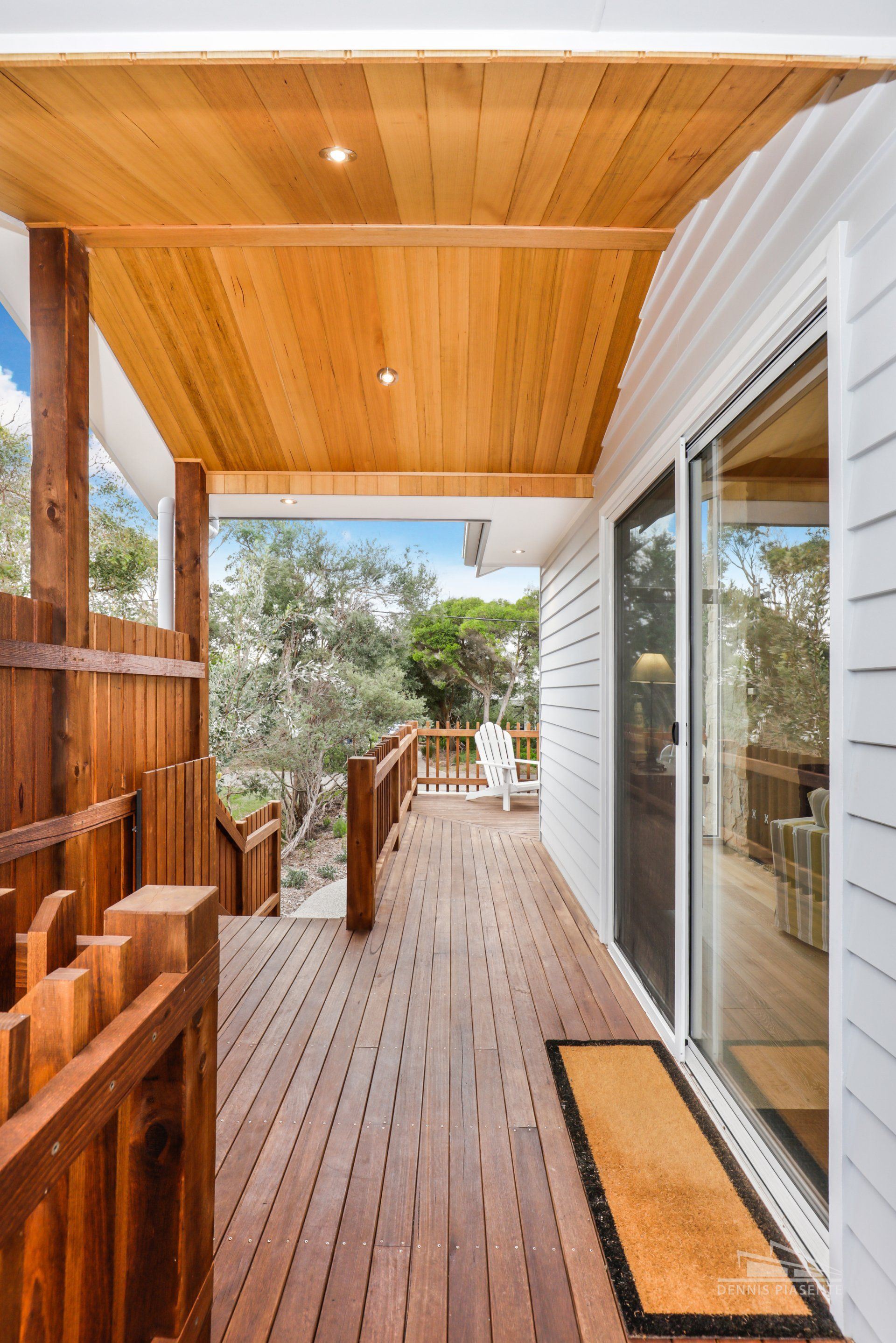 A wooden deck with a sliding glass door