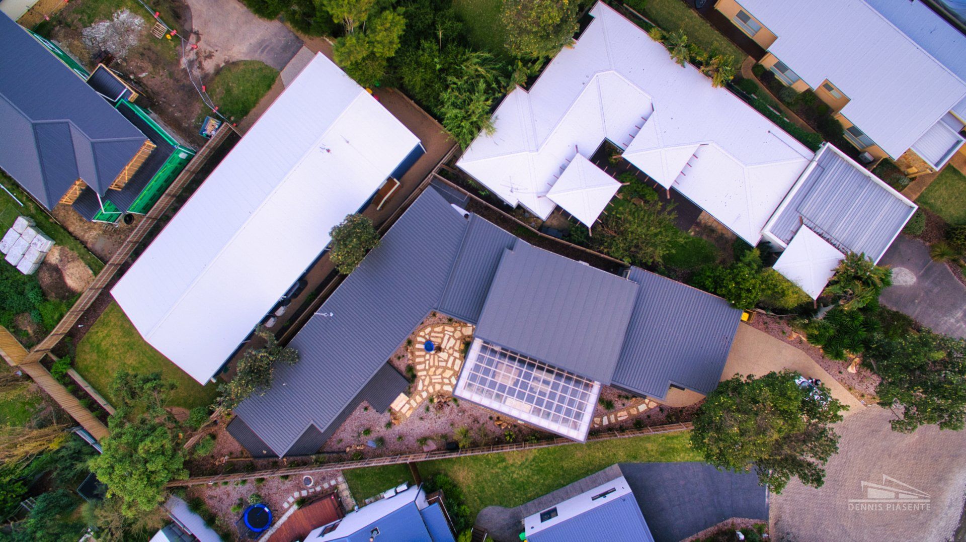 An aerial view of a residential area with lots of houses and trees