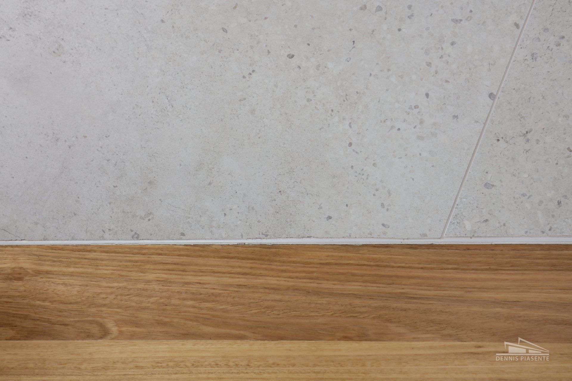 A wooden table with a concrete wall in the background.