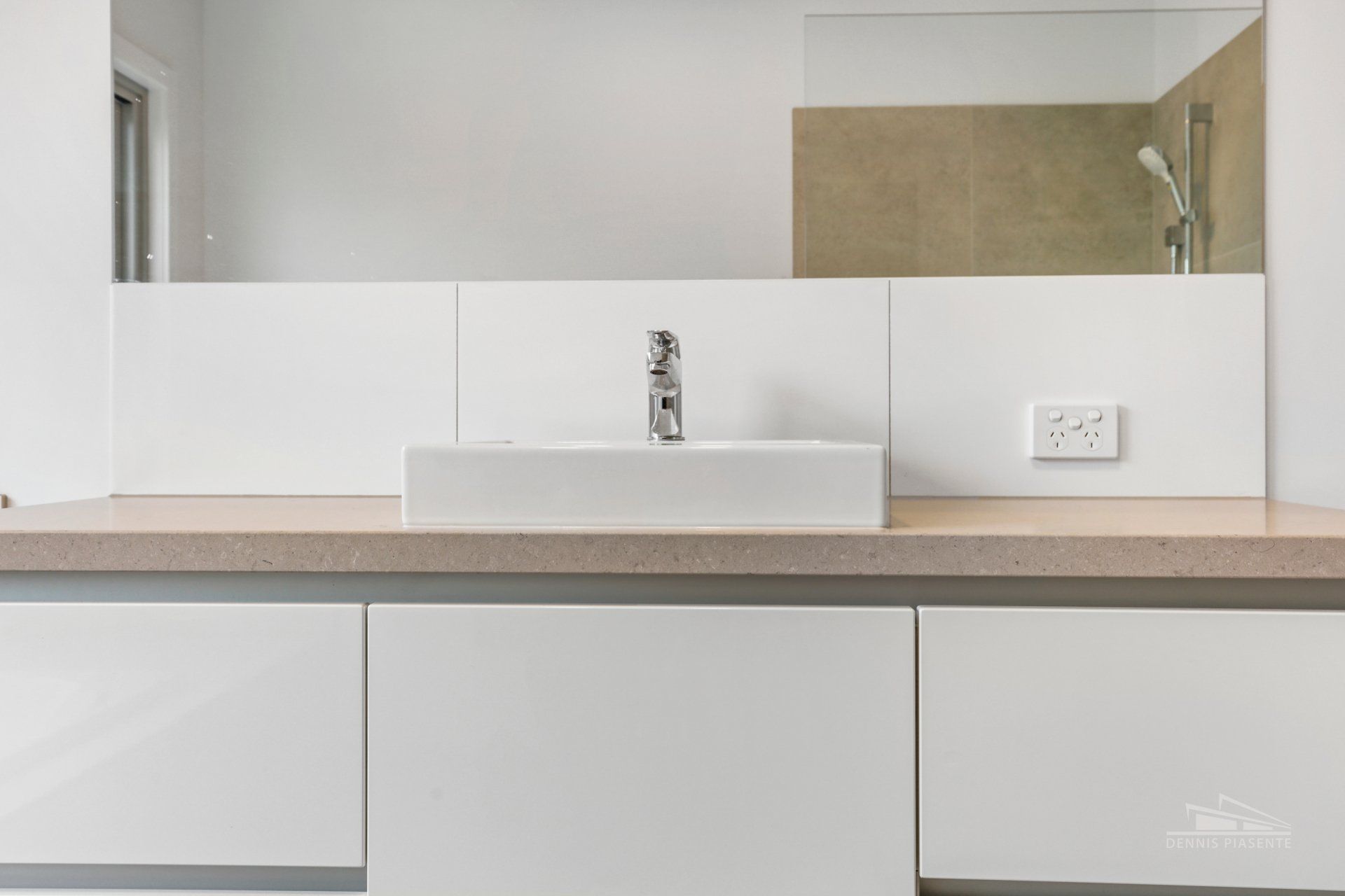 A bathroom with a sink and a large mirror.