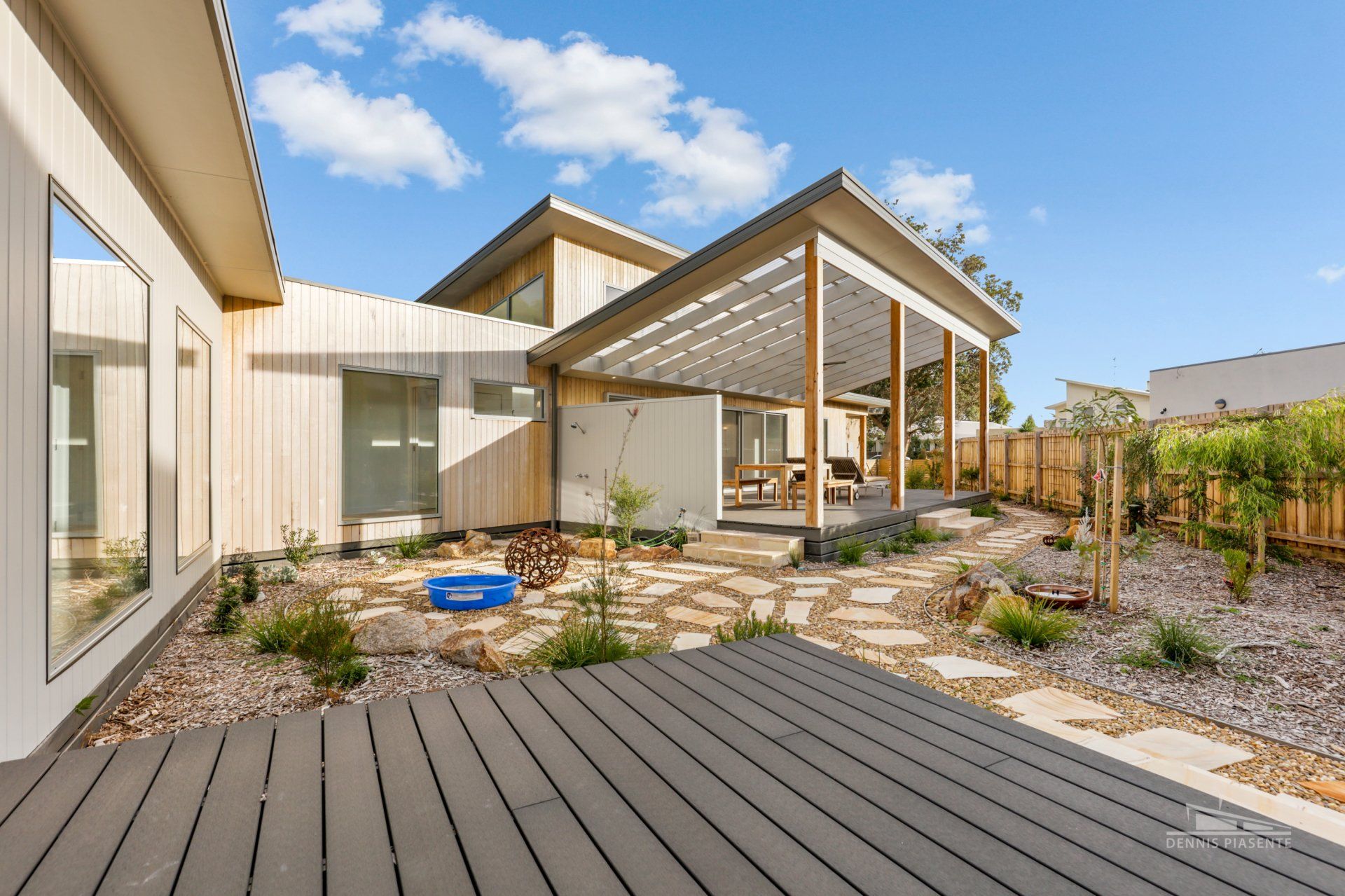 A large house with a large deck in front of it.
