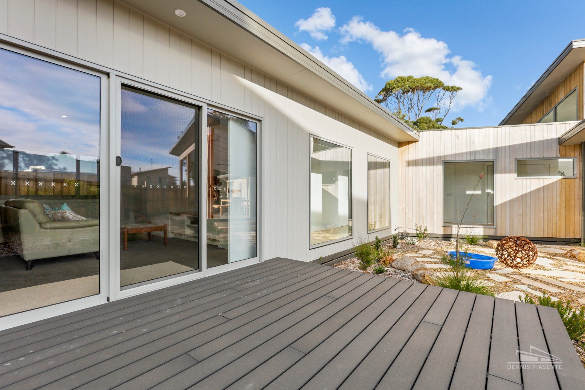 A house with a large deck and sliding glass doors