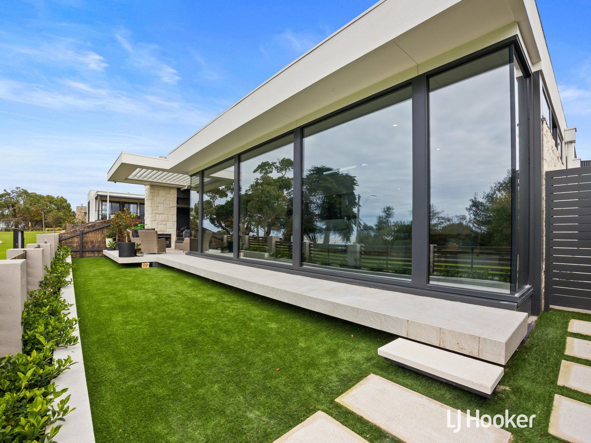 A modern house with a lot of windows is for sale