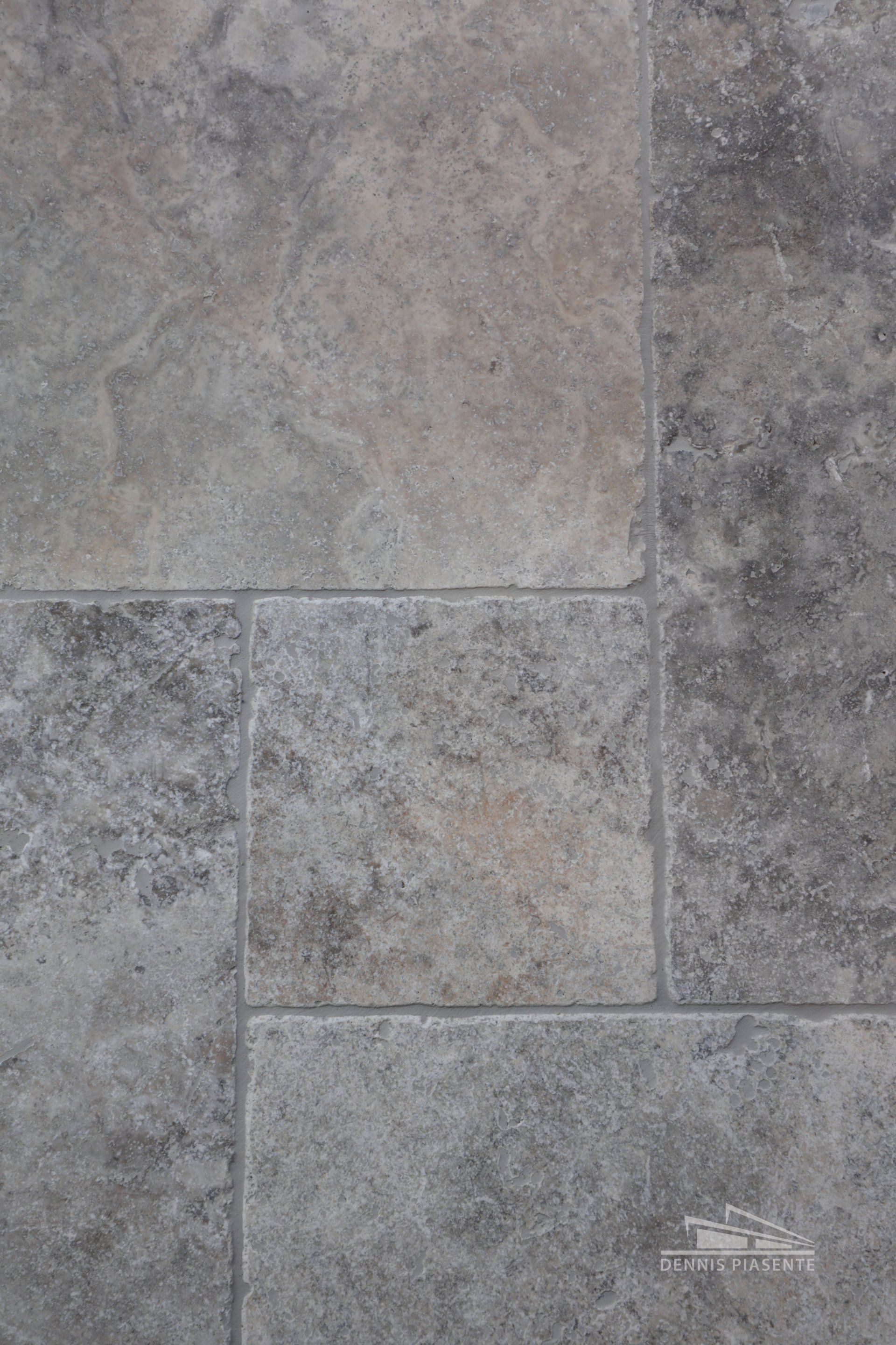 A close up of a gray tile floor.