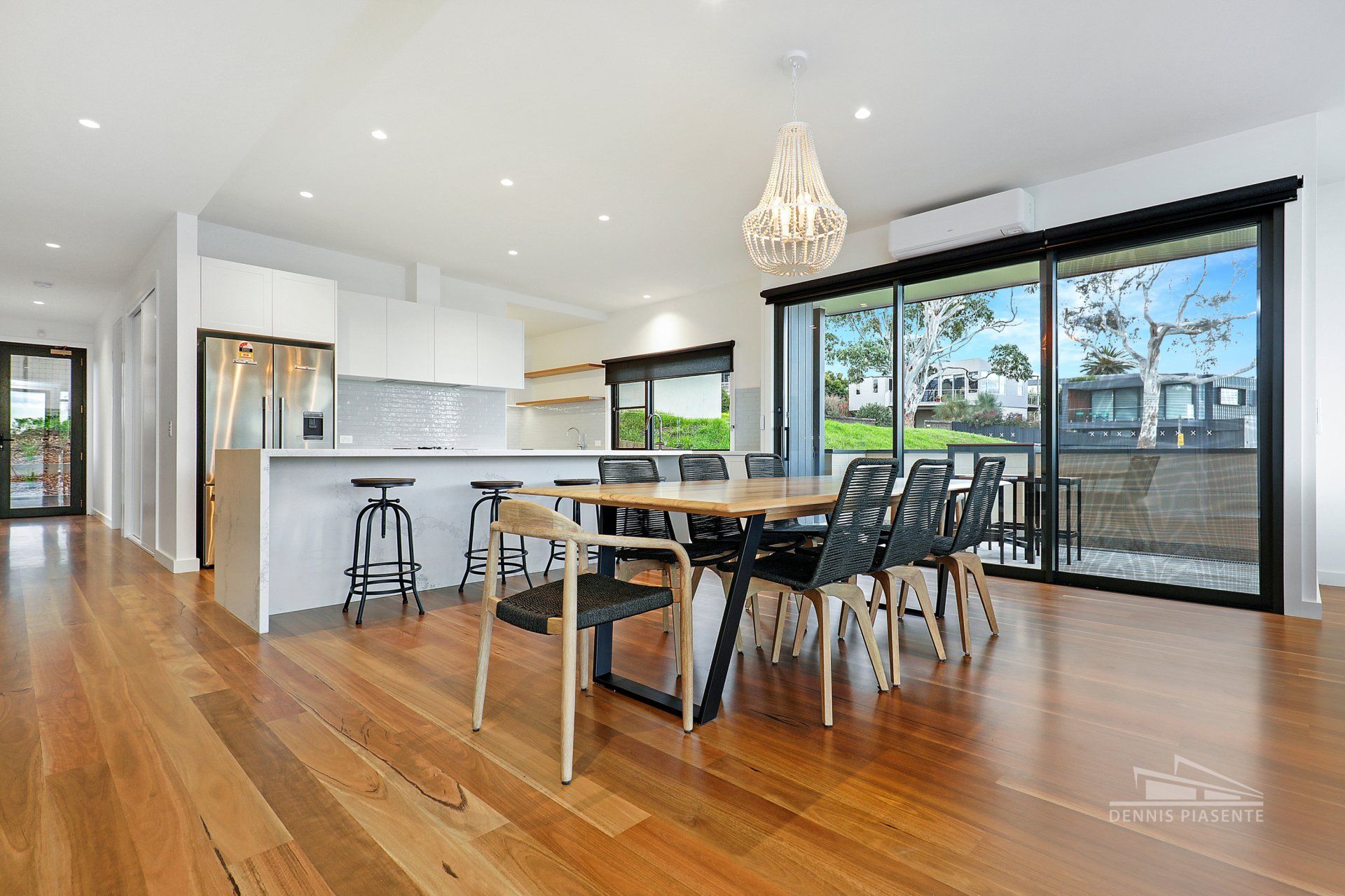 There is a dining table and chairs in the middle of the room.