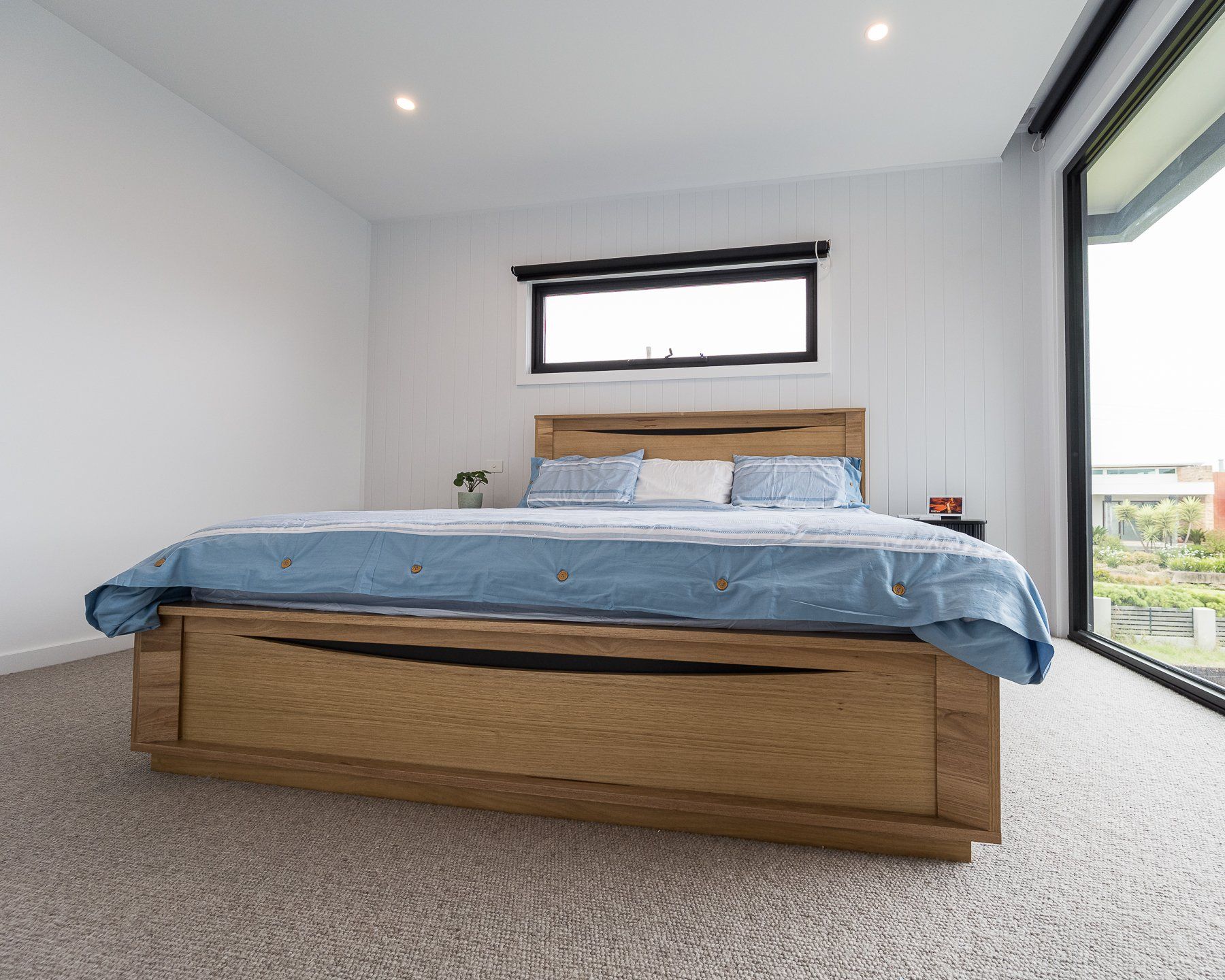 A bedroom with a large bed and a window.