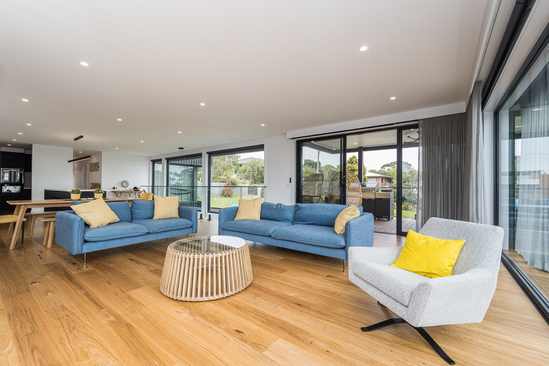 A living room with two couches , a chair , and a coffee table.
