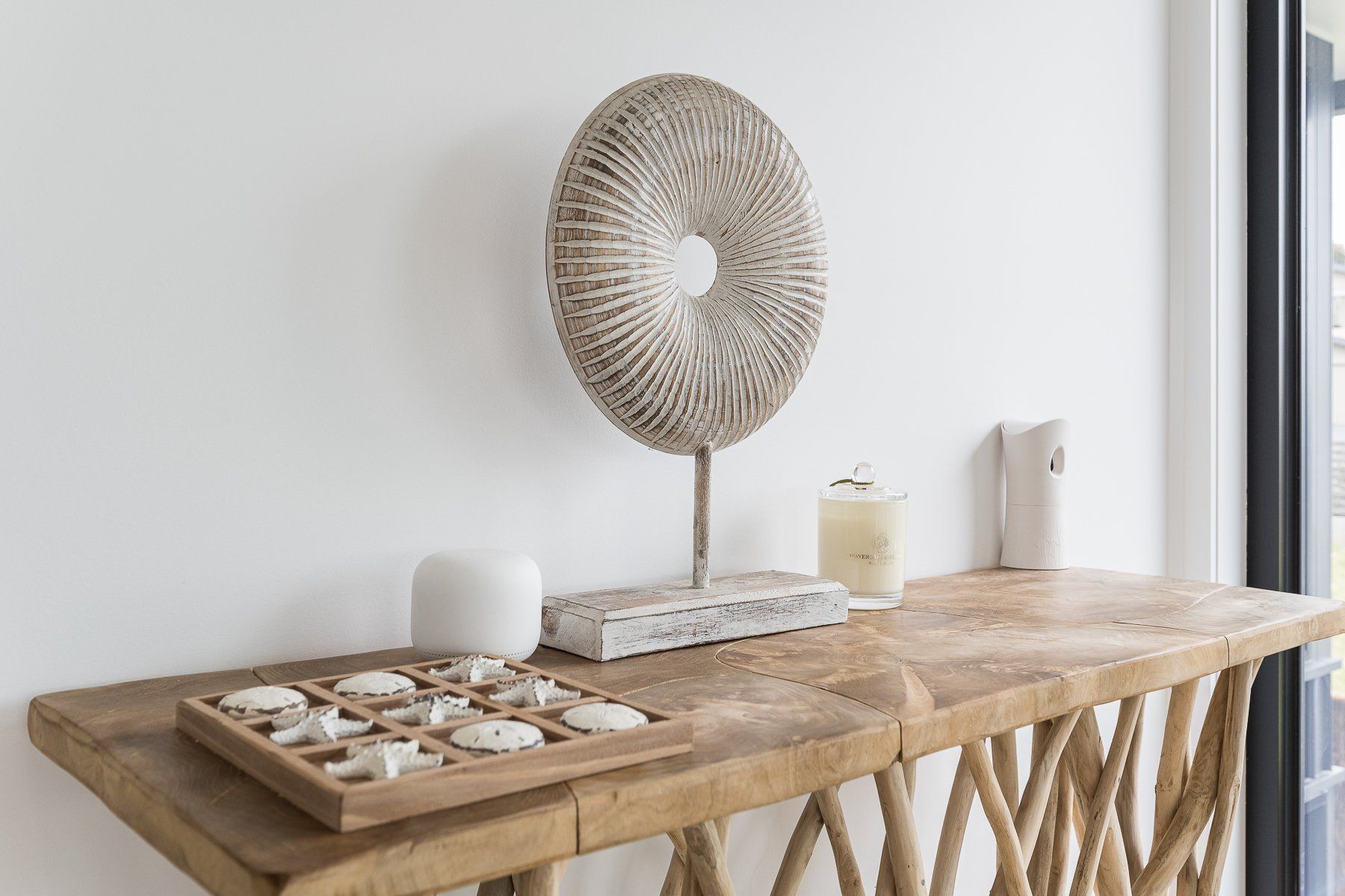 A wooden table with a wicker sculpture on top of it.
