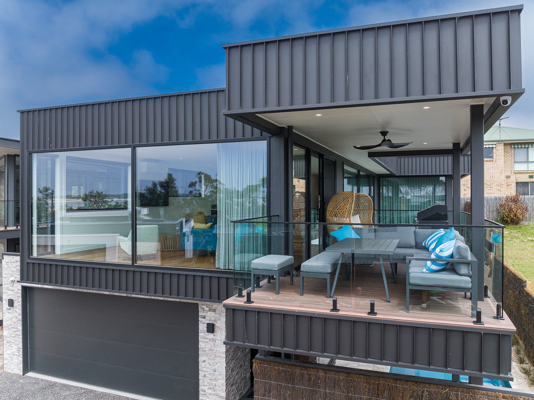 A modern house with a large balcony and a large window.