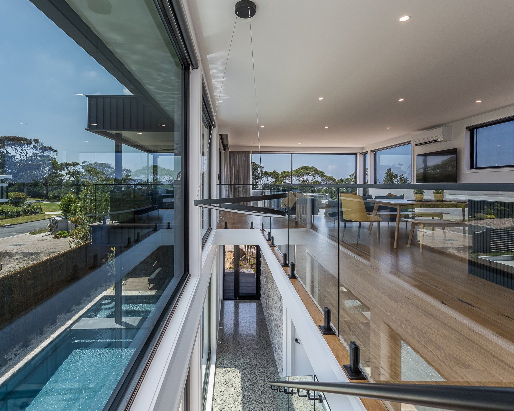 A view of a swimming pool from the second floor of a house