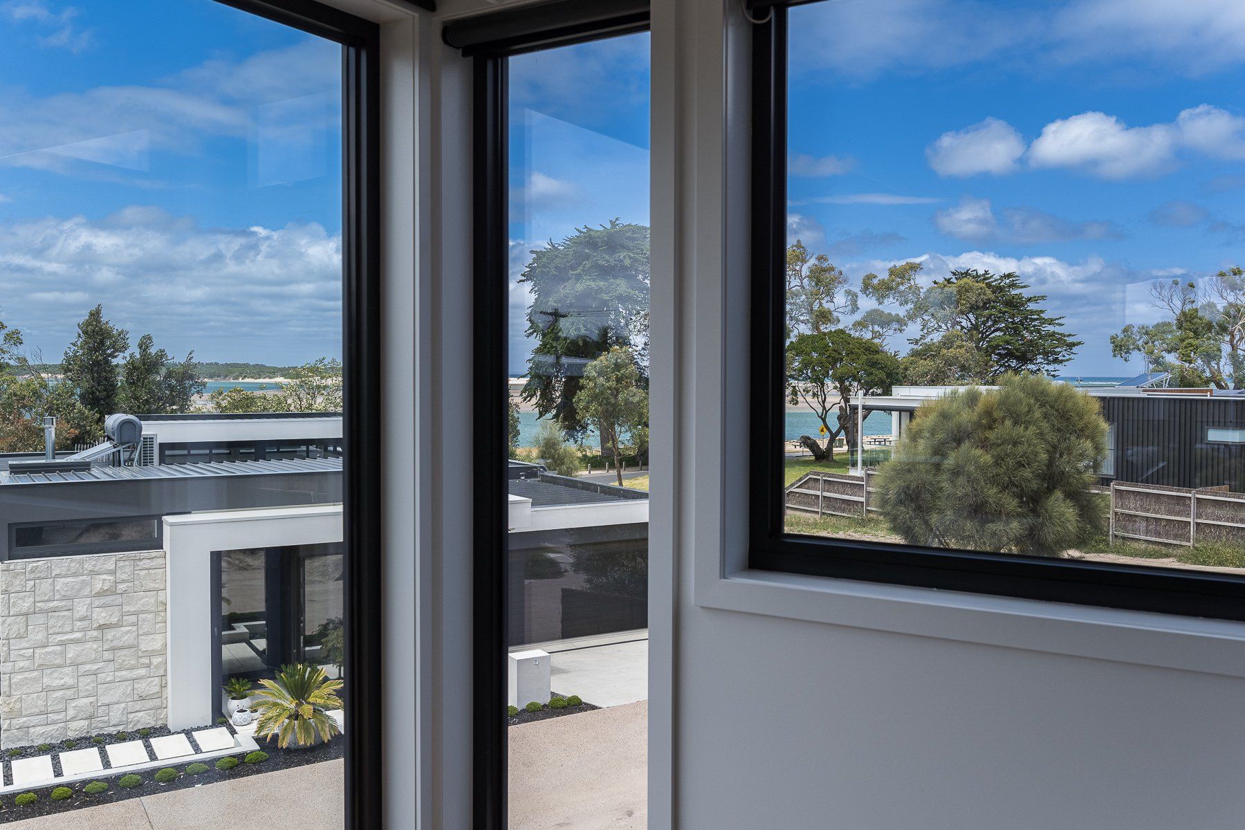 A room with a lot of windows and a view of a house.