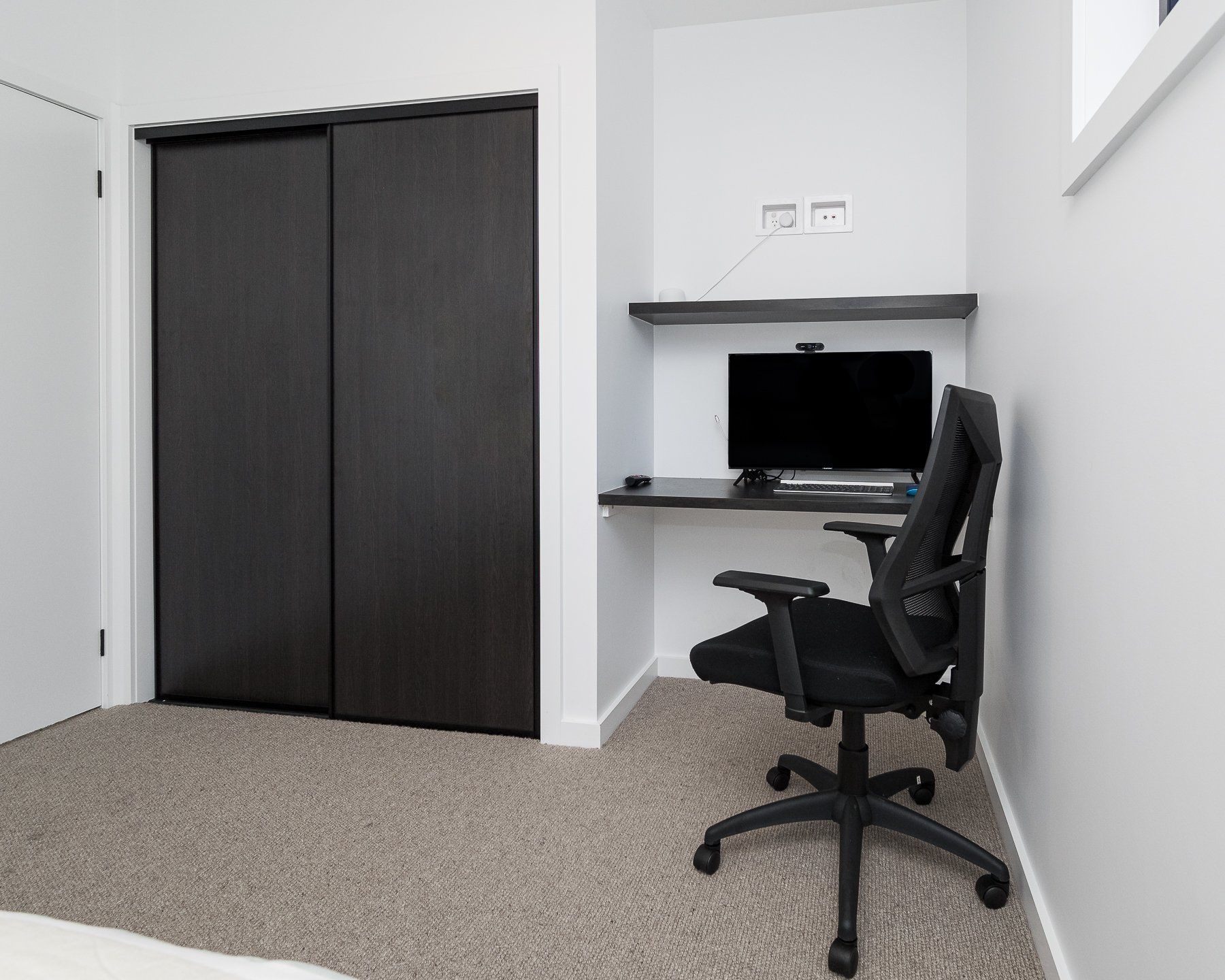 A room with a desk and a chair in it