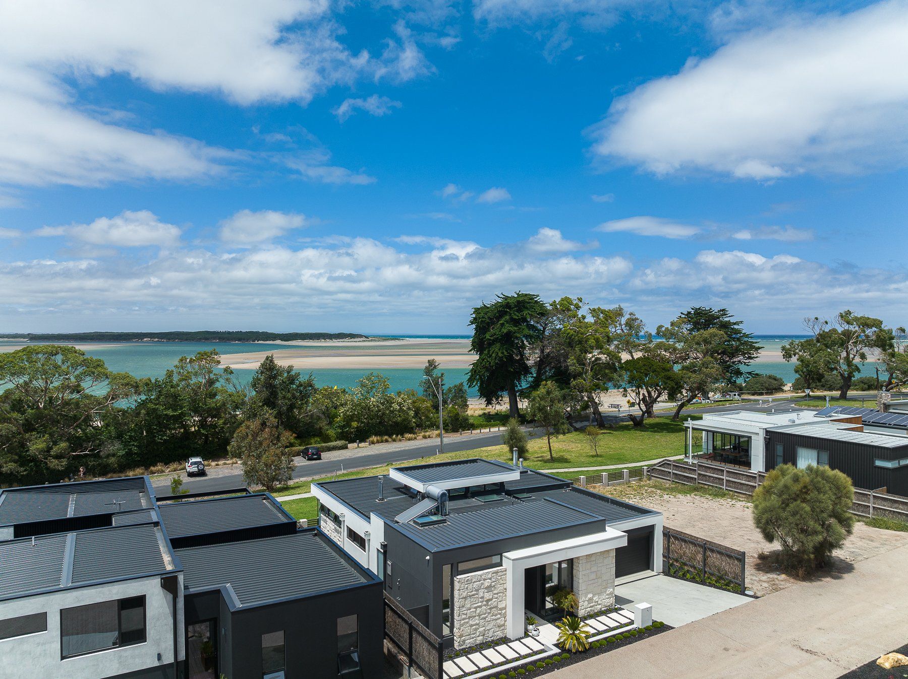 An aerial view of a row of houses next to a body of water.