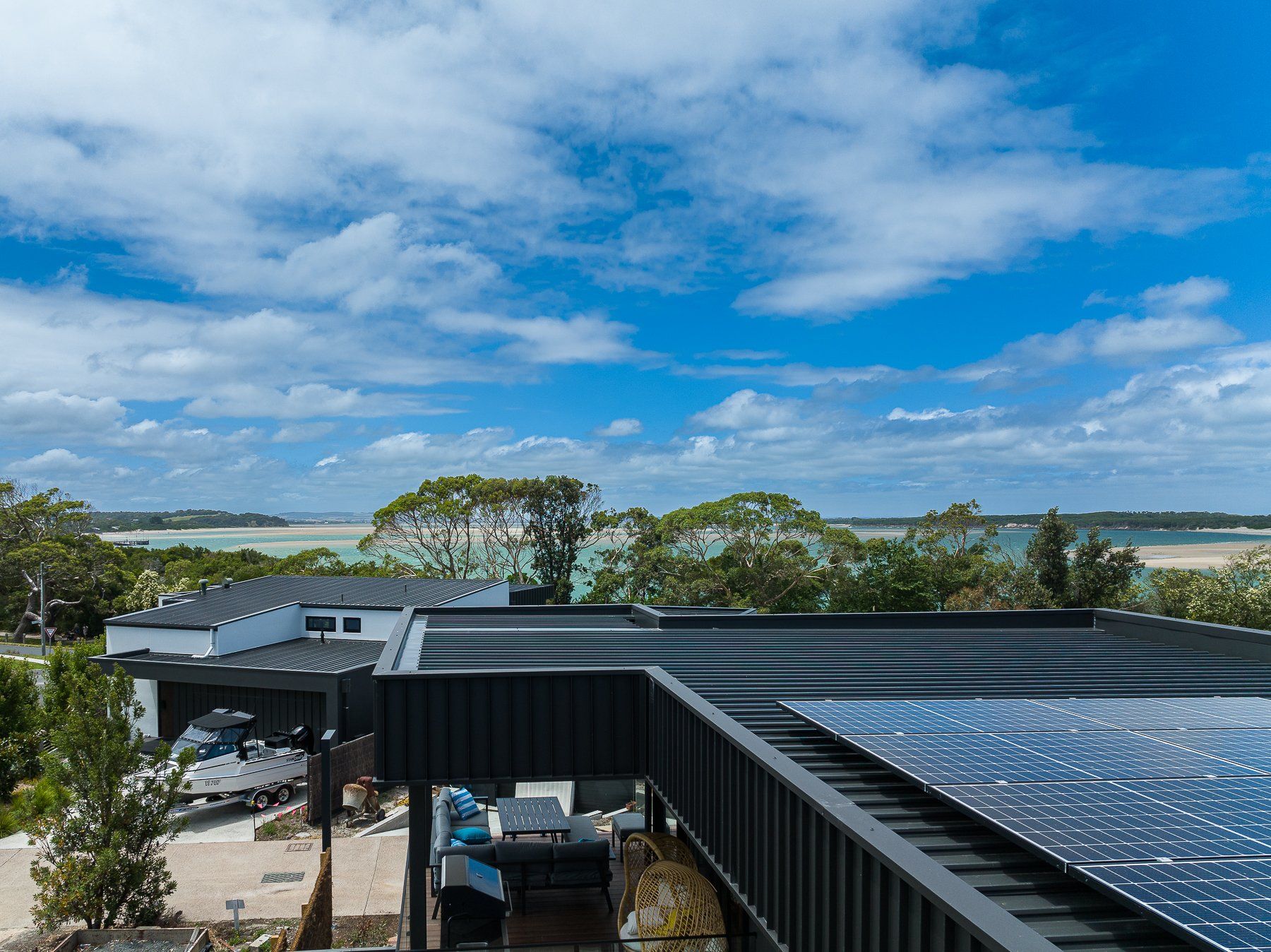 A view of the ocean from the roof of a house.