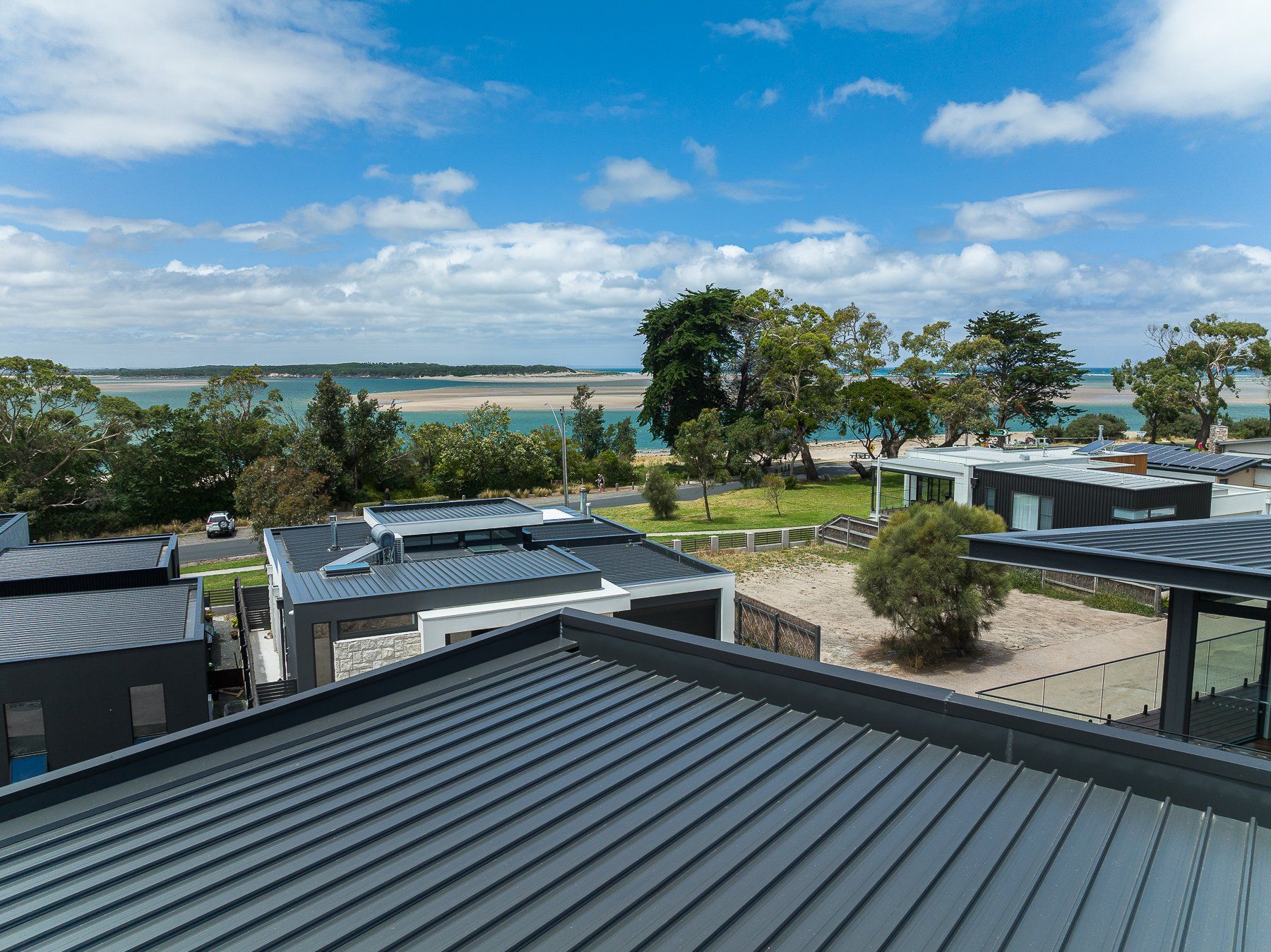 A view of the ocean from the roof of a house.
