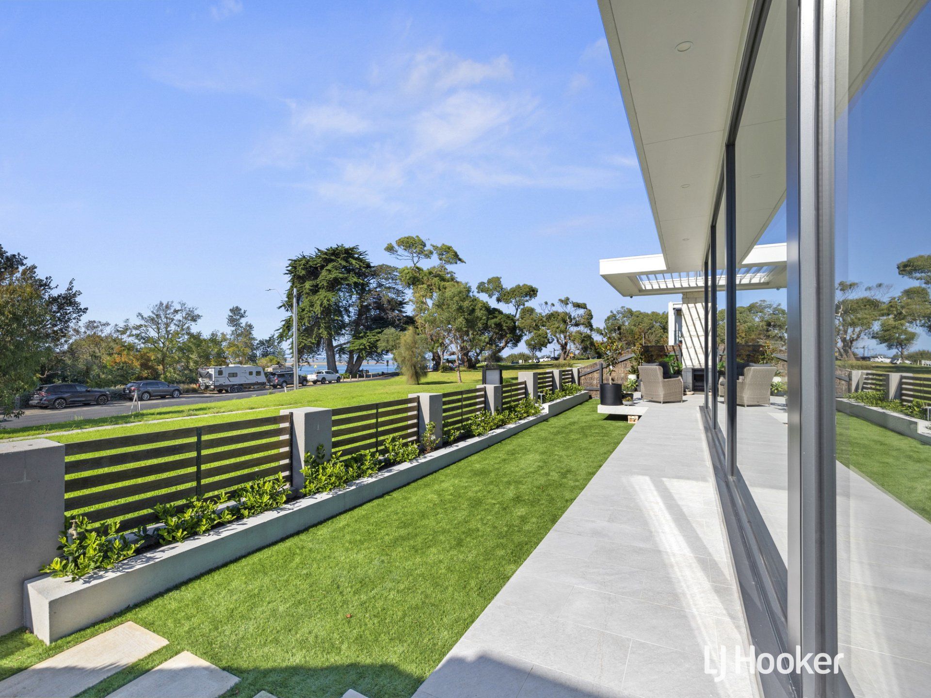 A large house with a lot of windows and a lawn in front of it.