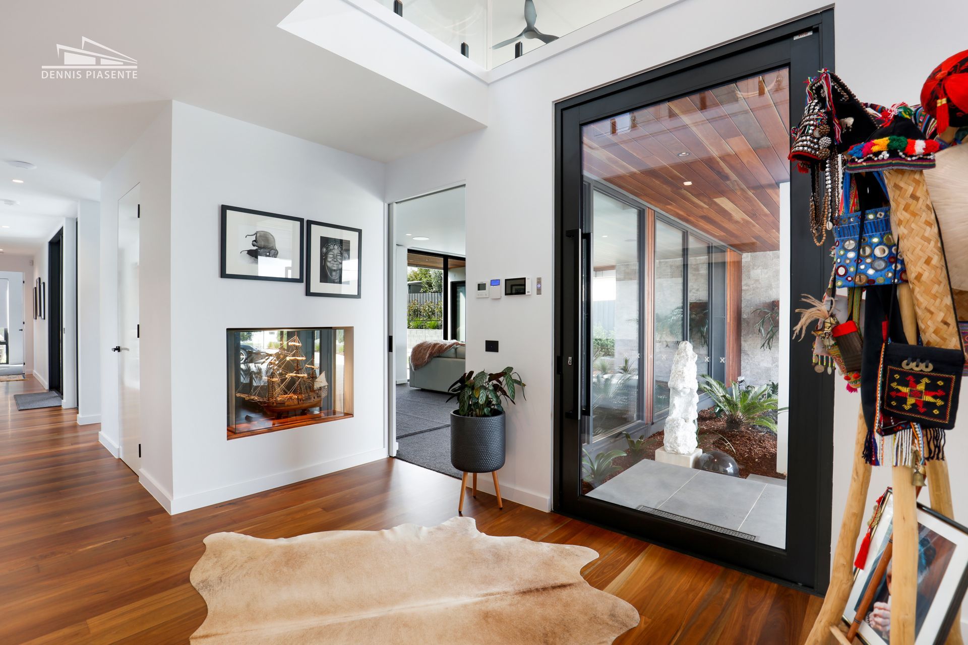 A living room with hardwood floors , a rug and a fireplace.