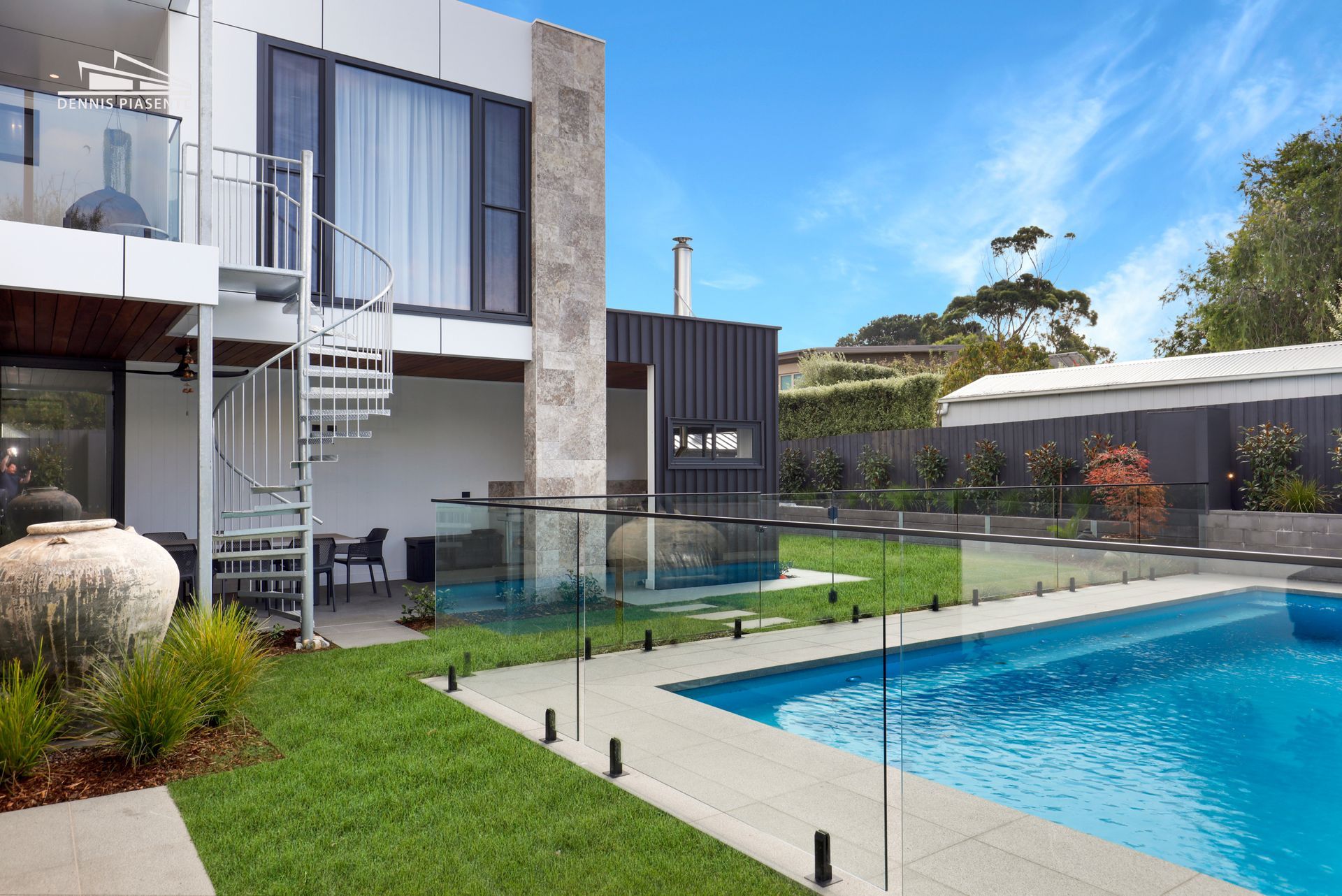 A large house with a swimming pool in front of it.