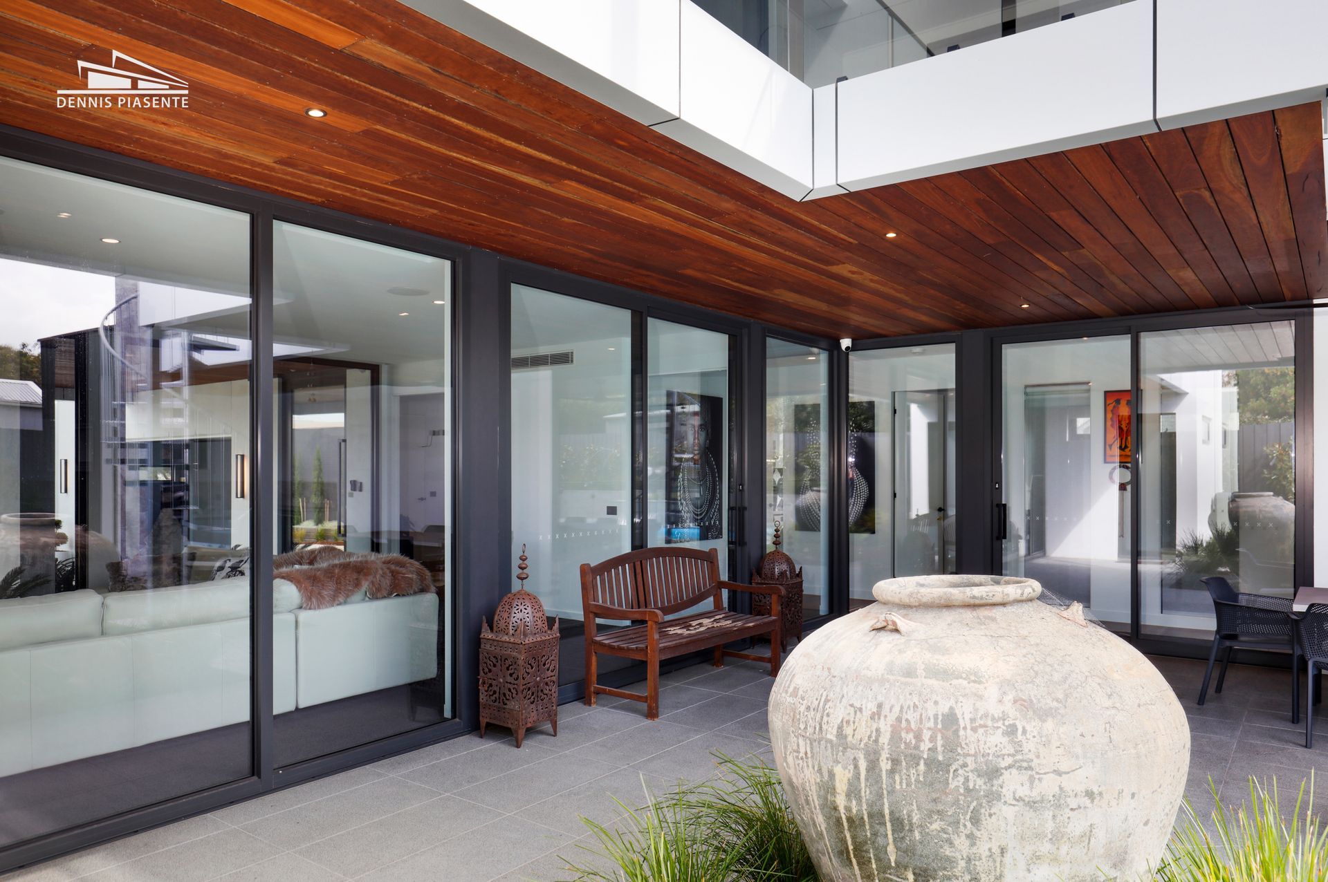 There is a large vase in the middle of the courtyard of a house.