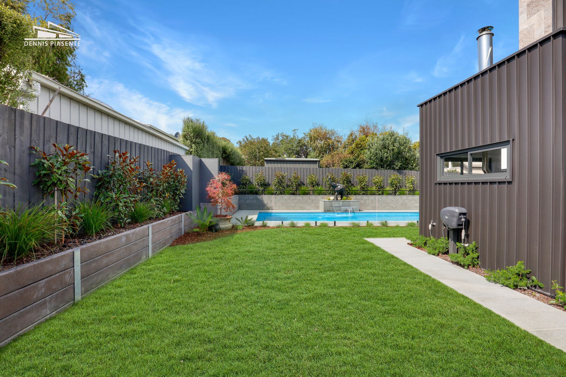 There is a swimming pool in the backyard of a house.