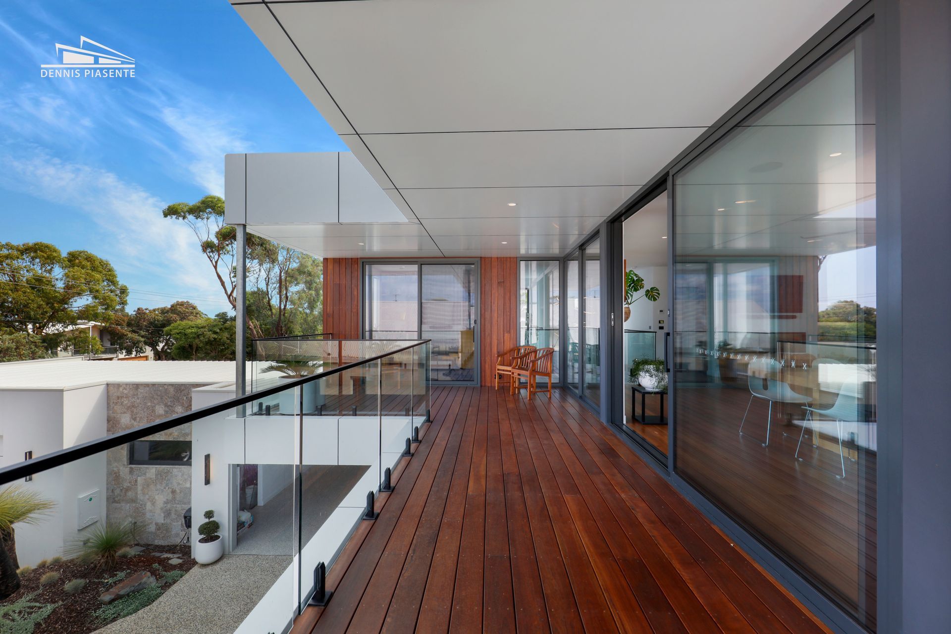 A balcony in a modern house with a glass railing