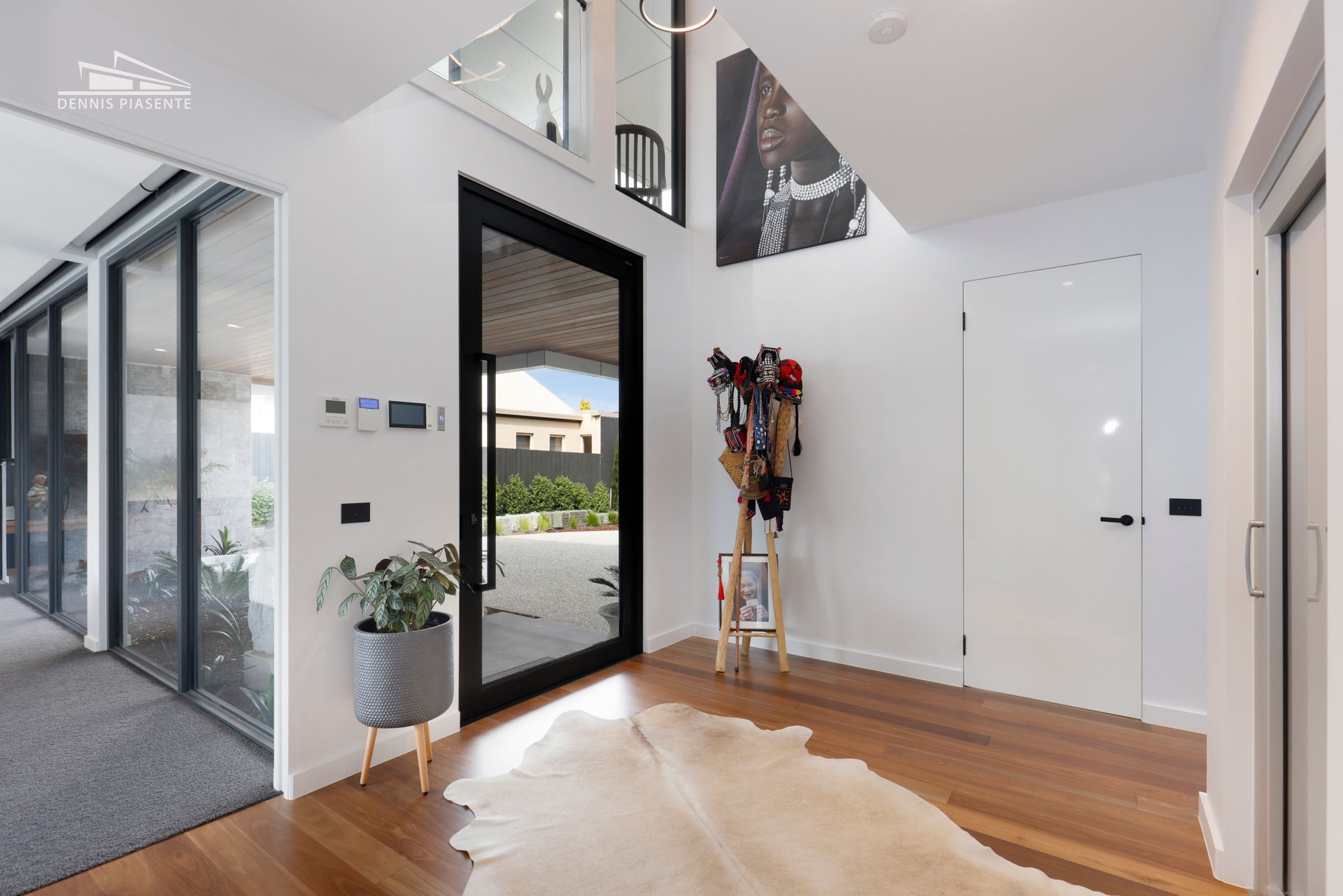A hallway in a house with a cowhide rug on the floor.