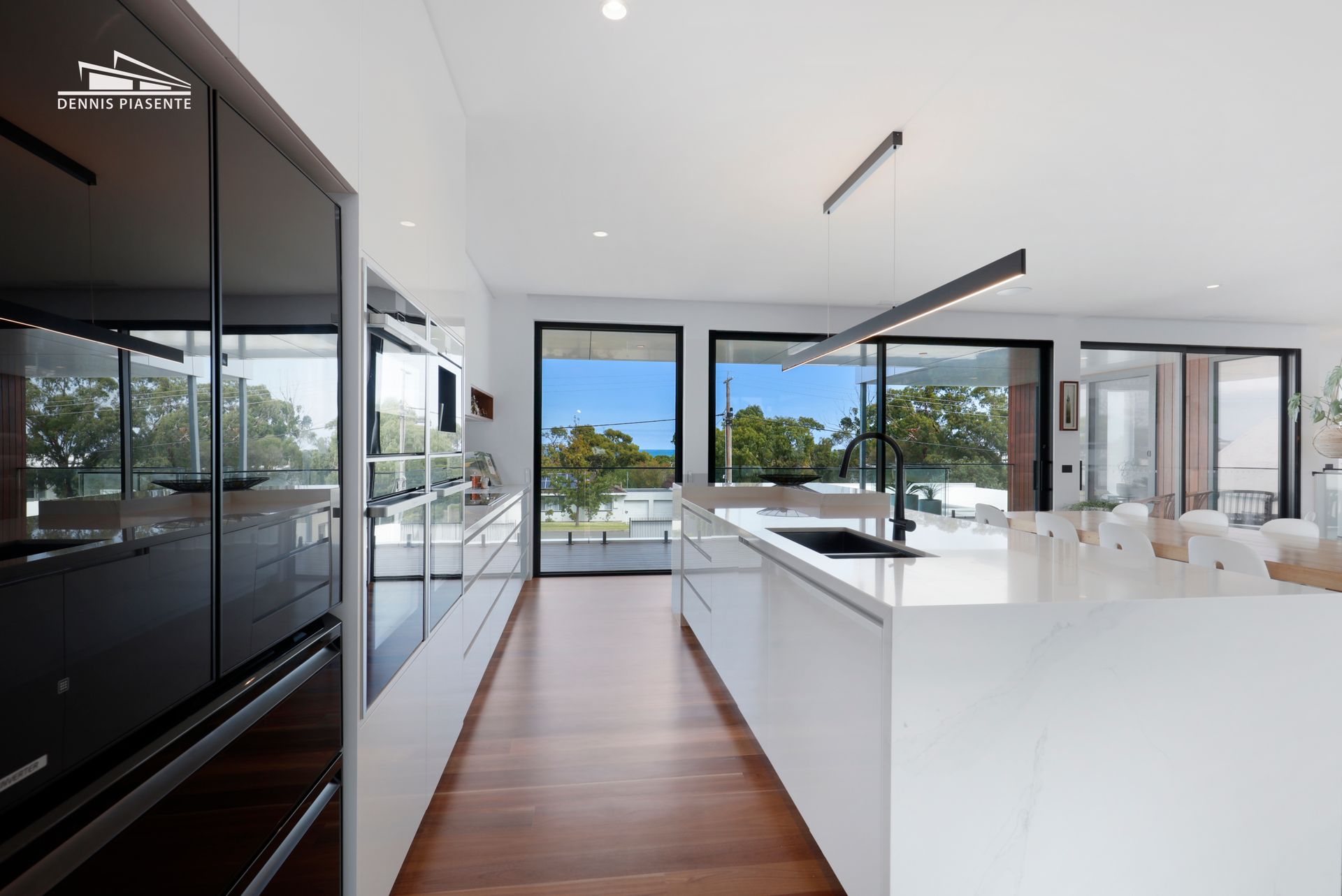 A kitchen with a large island and lots of windows