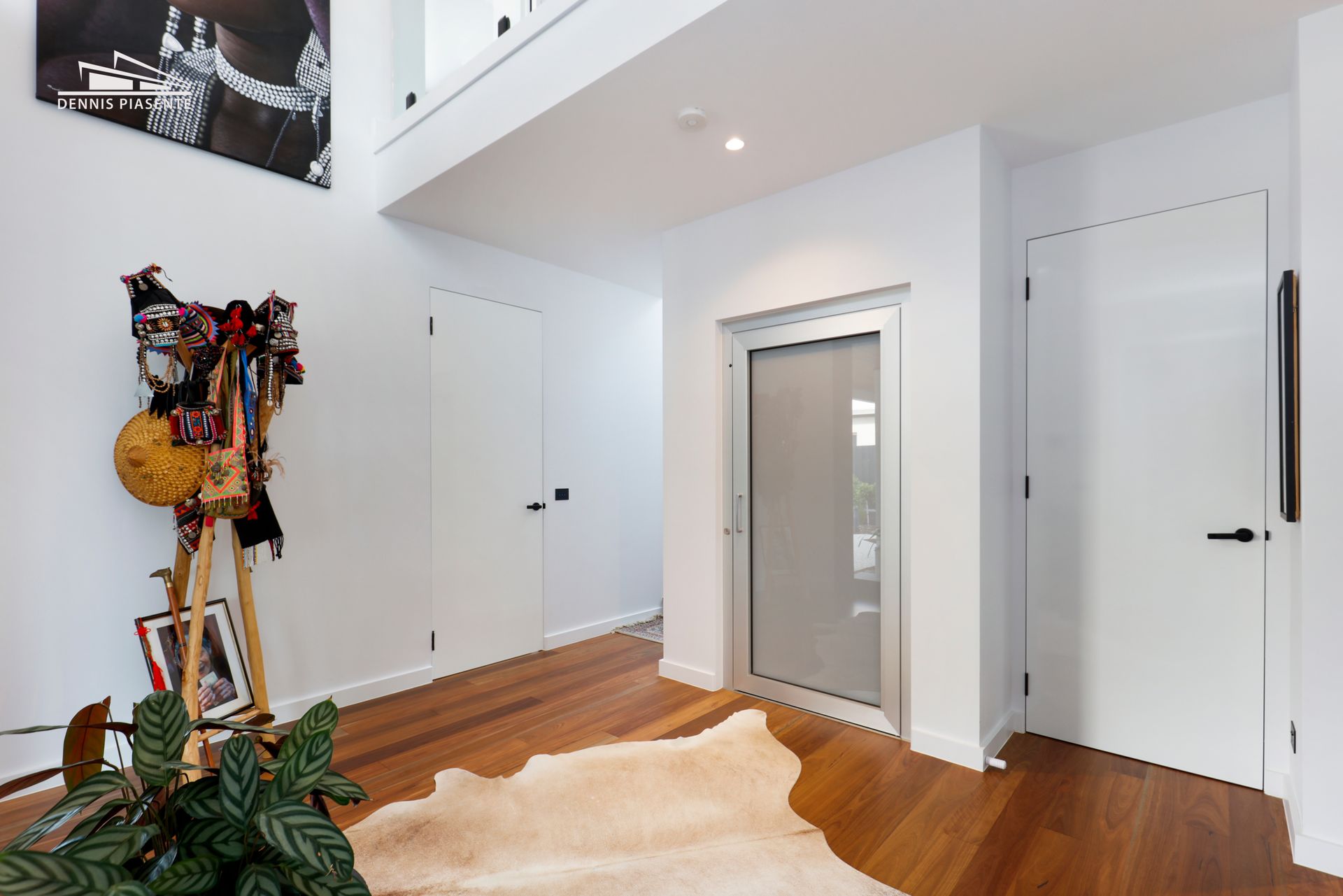 There is a cowhide rug on the floor in the hallway.