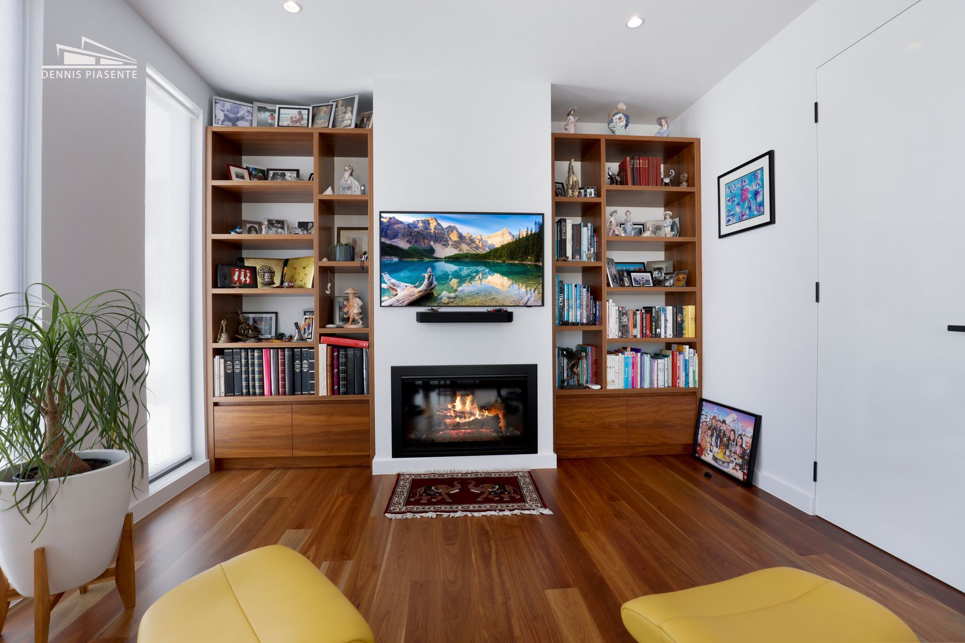A living room with a fireplace and a flat screen tv