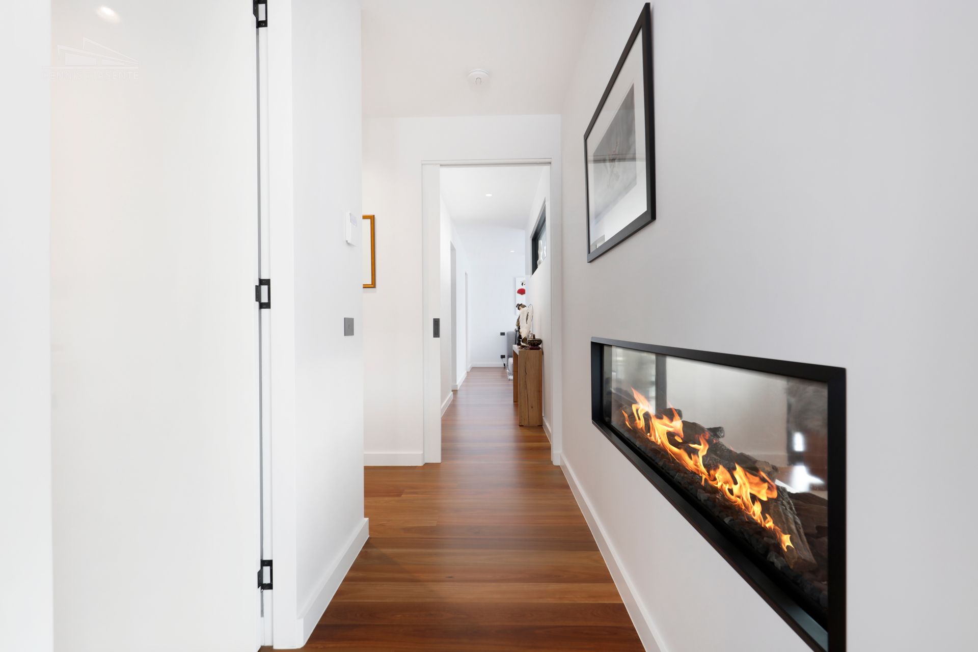 There is a fireplace in the middle of the hallway.