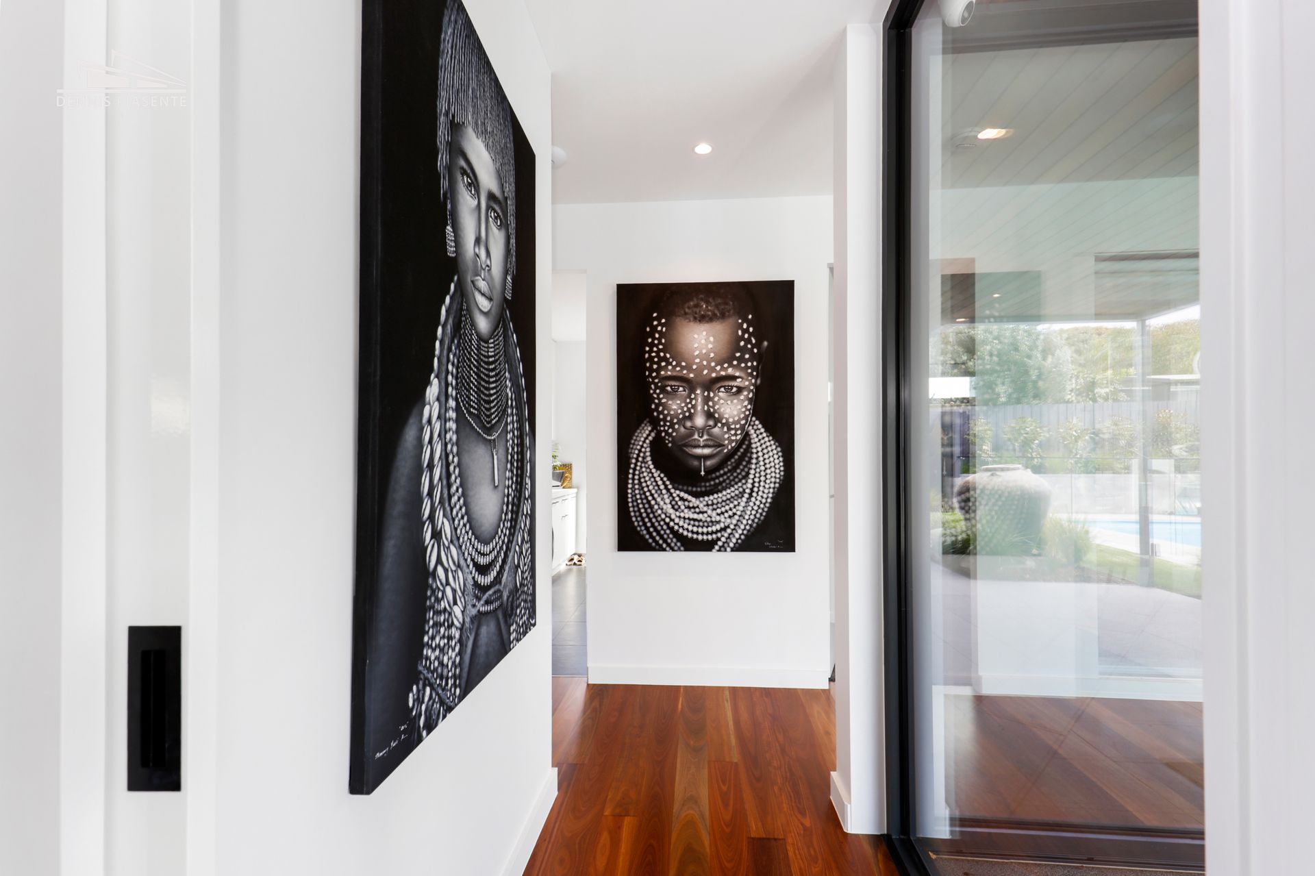 A hallway with a painting of a man on the wall.