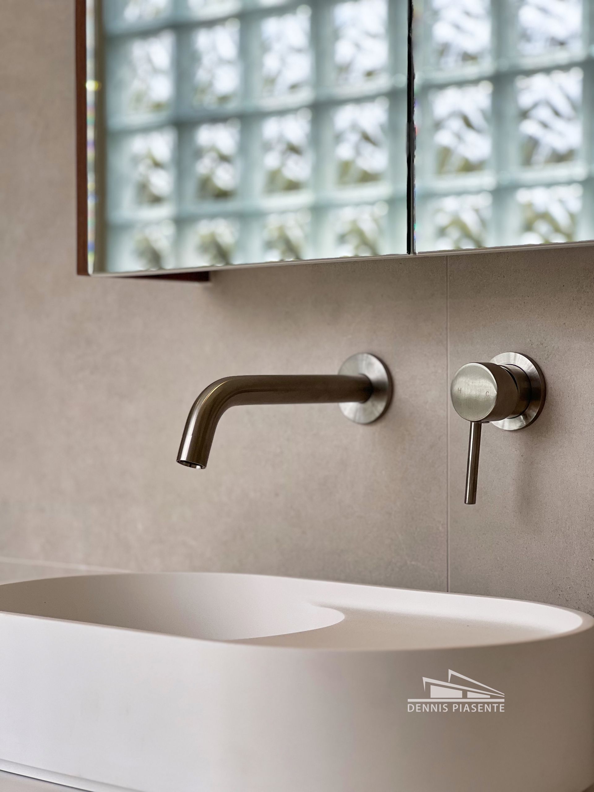 A bathroom sink with a mirror above it