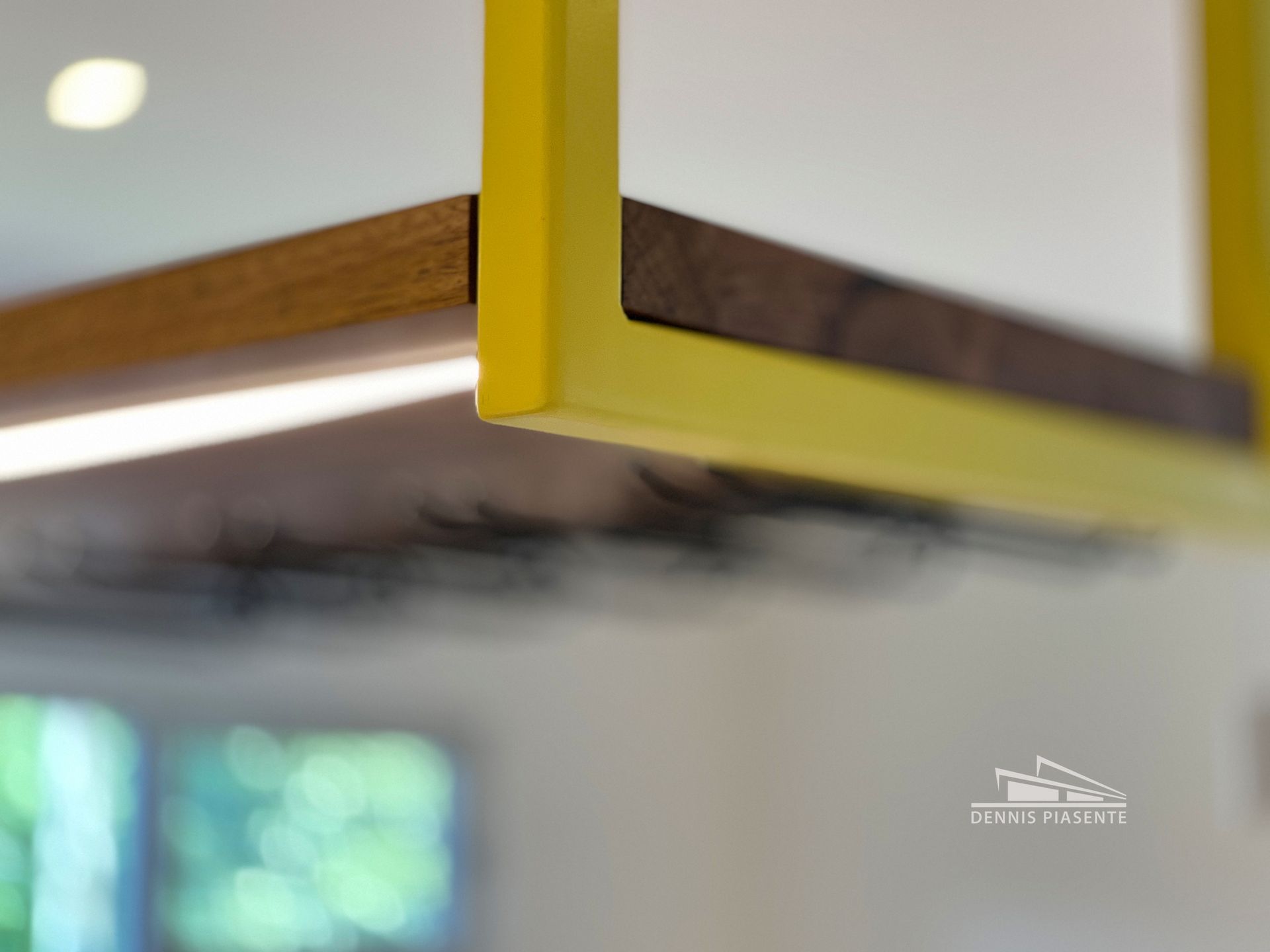 A yellow frame is hanging from the ceiling in a kitchen