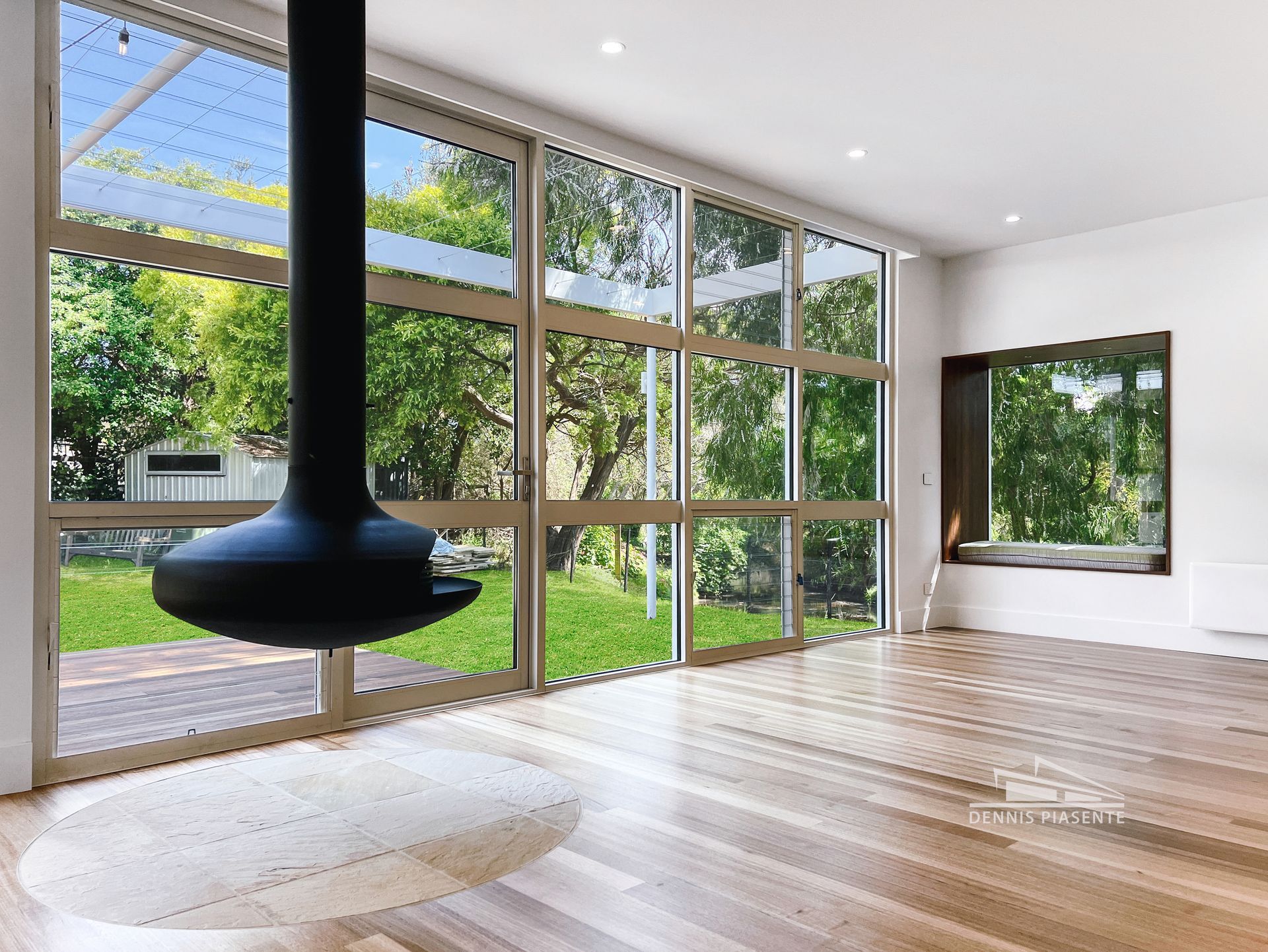 A living room with a fireplace and lots of windows