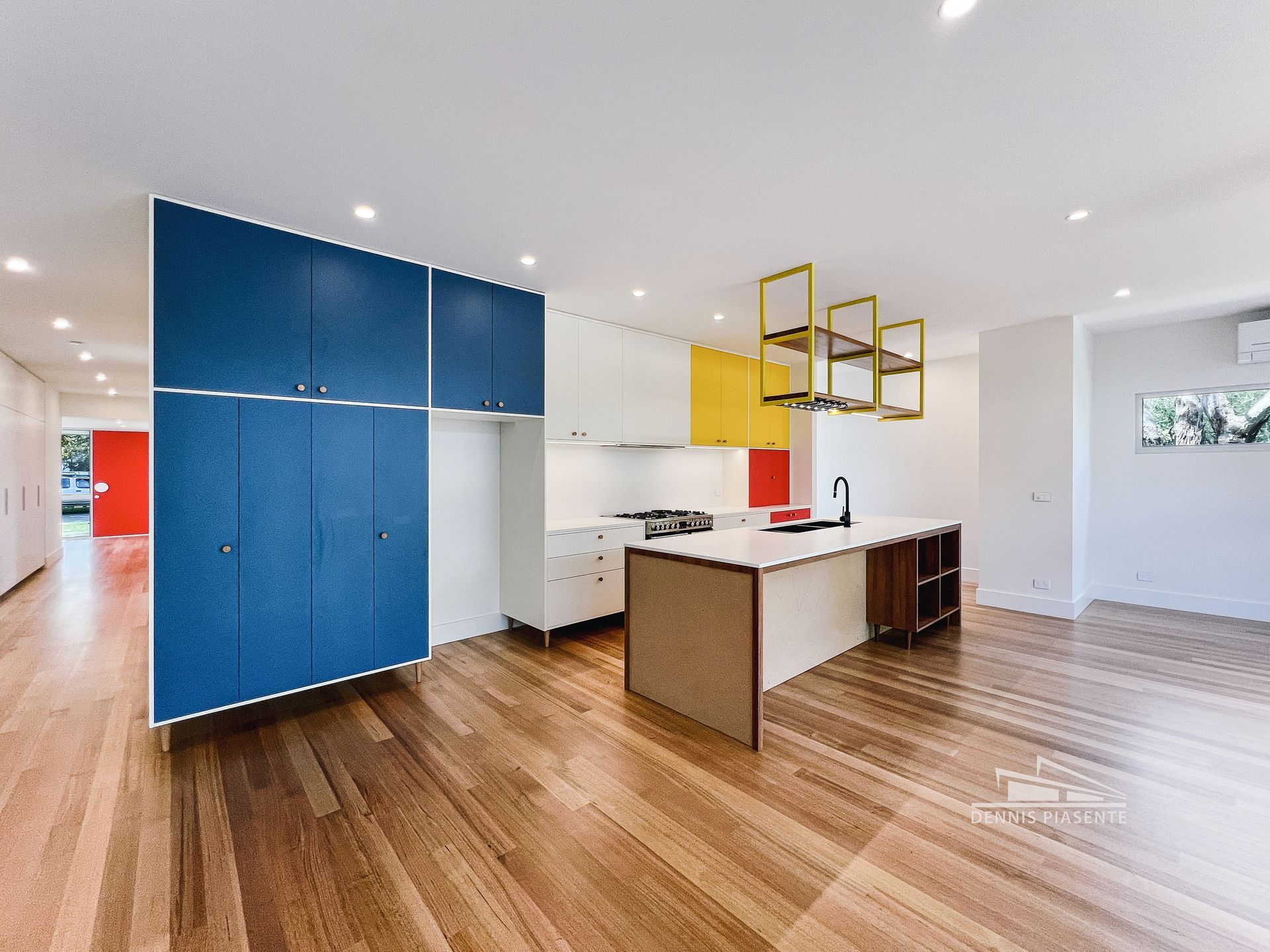 A kitchen with wooden floors and blue cabinets