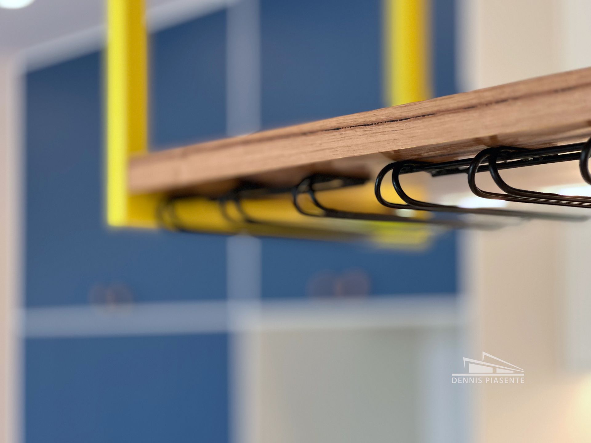 A wooden shelf with a bunch of hooks on it