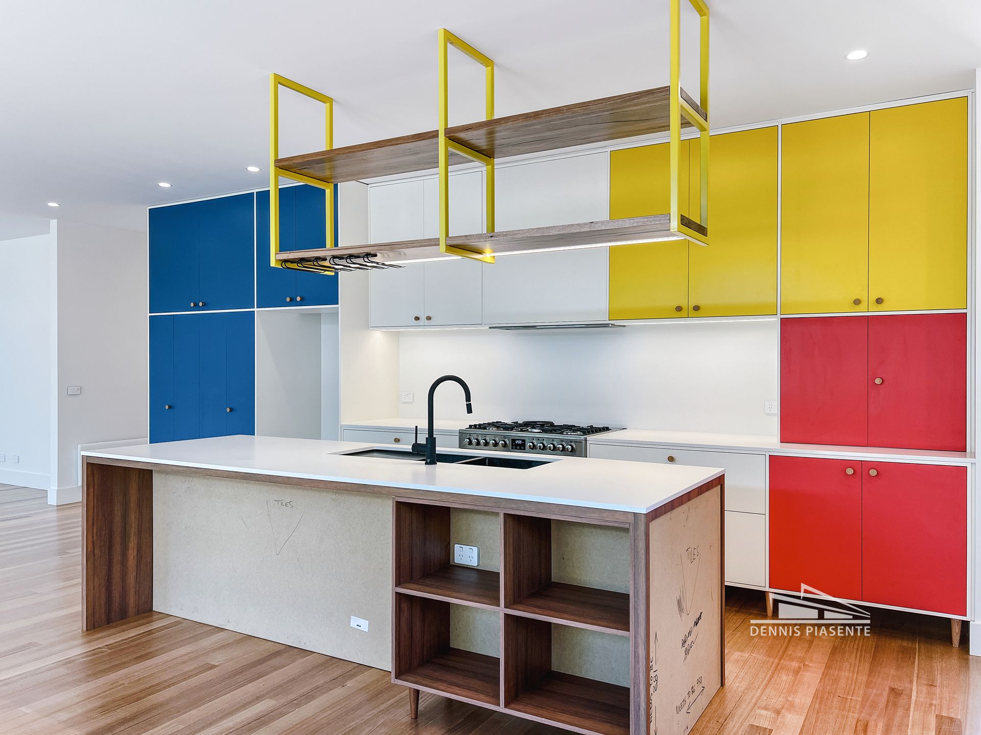 A kitchen with colorful cabinets and a sink