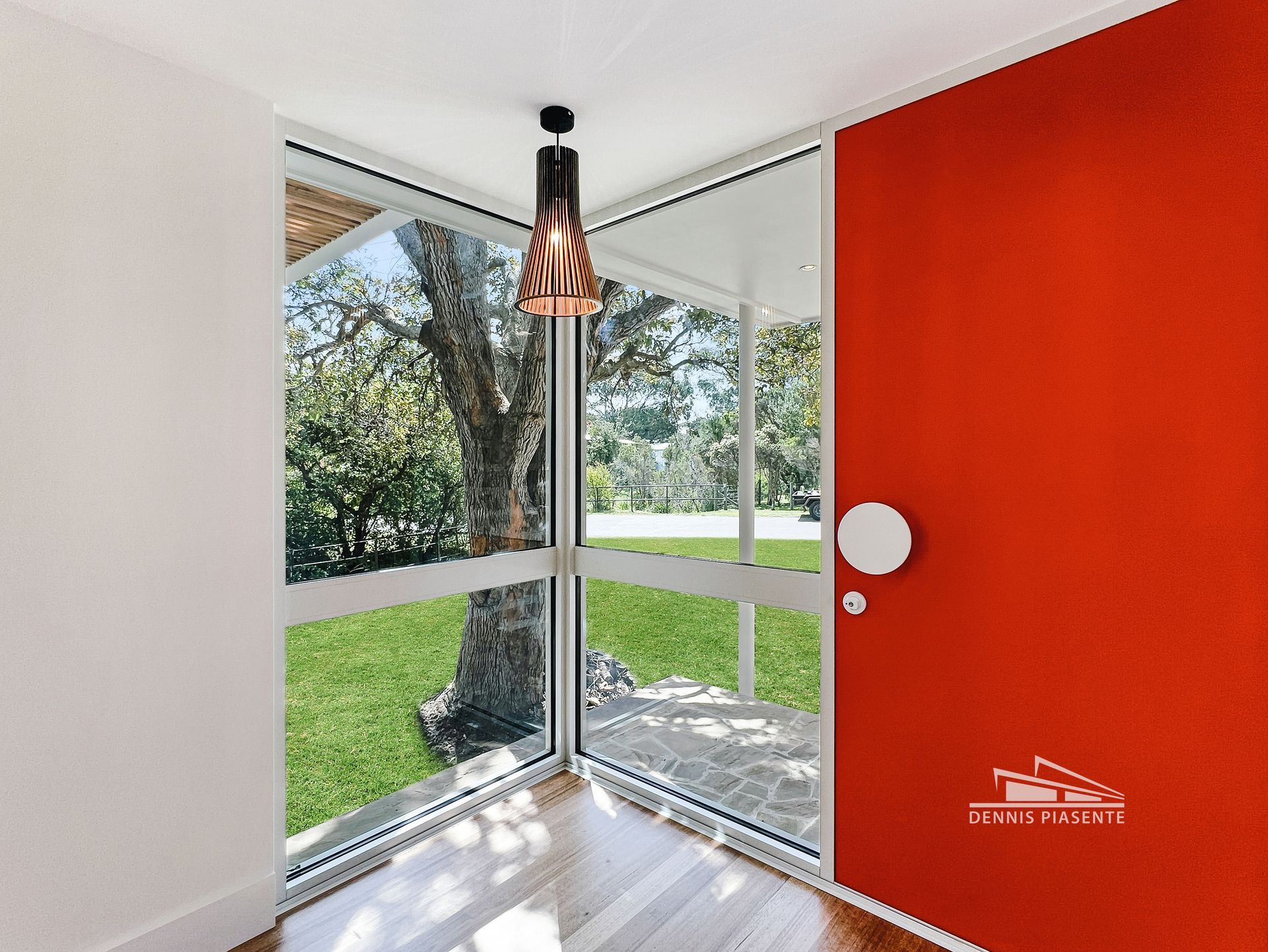 A room with a red door and a large window