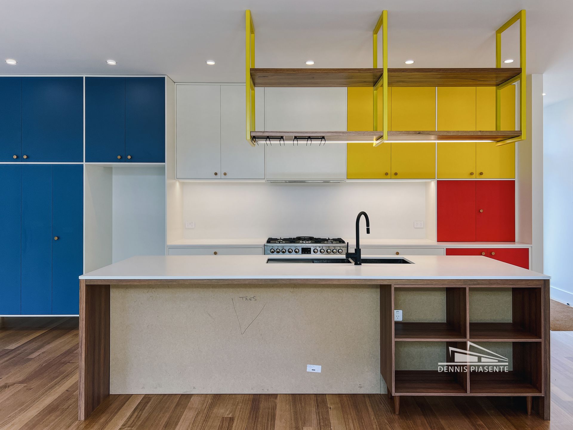 A kitchen with colorful cabinets and a sink