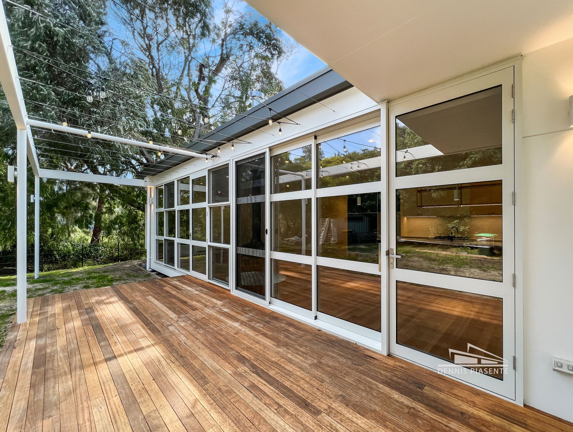 A large house with a lot of windows and a wooden deck.