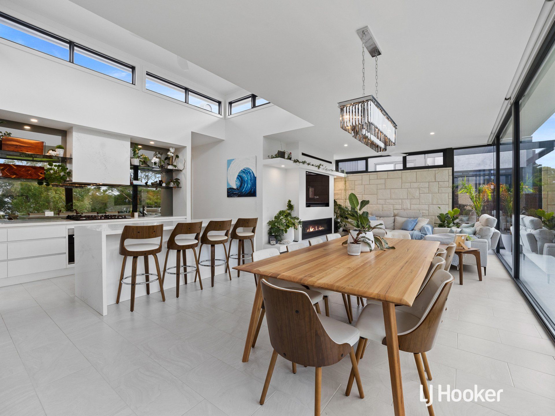 A large room with a wooden table and chairs in it