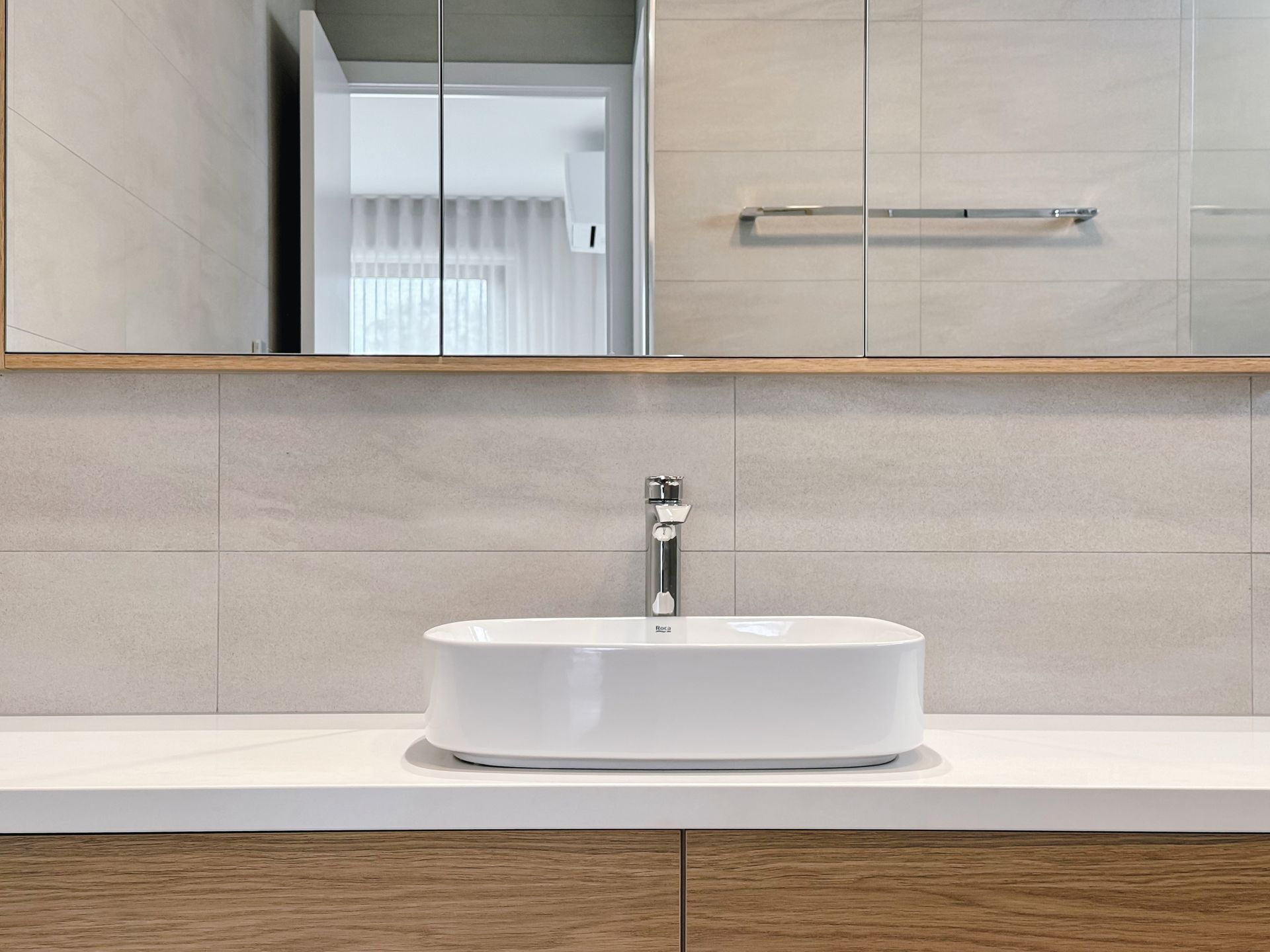 A bathroom with a sink and a mirror.