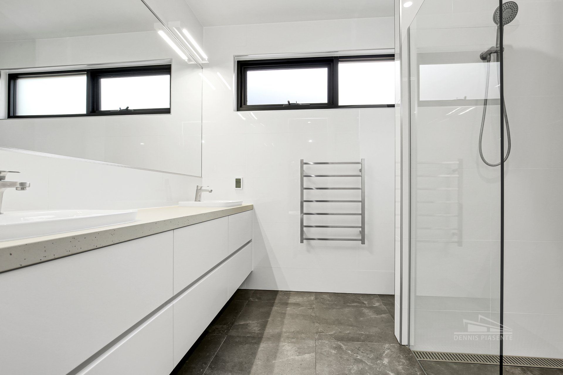 A bathroom with a sink and a walk in shower.