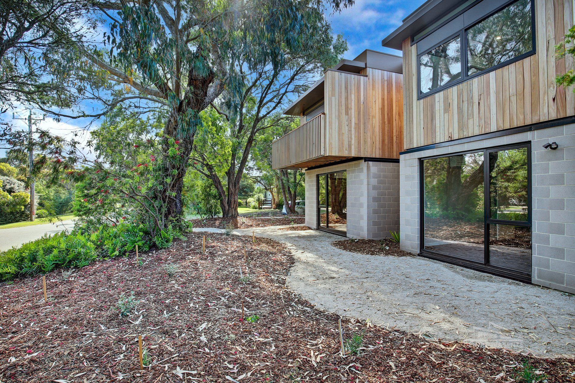 A large house with a lot of windows and trees in the background.
