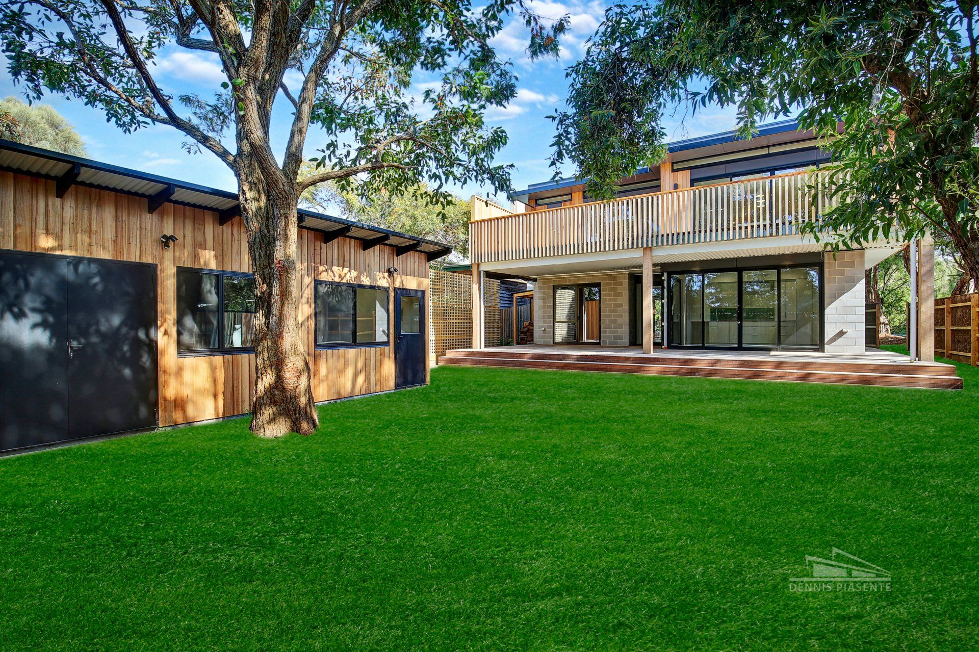 A large house with a lush green lawn in front of it.