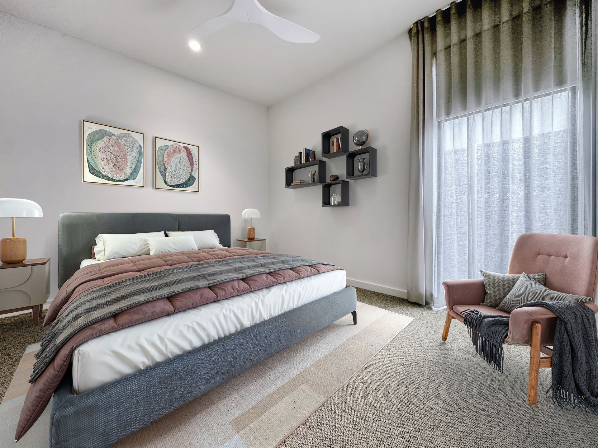 A bedroom with a large bed , chair and ceiling fan.