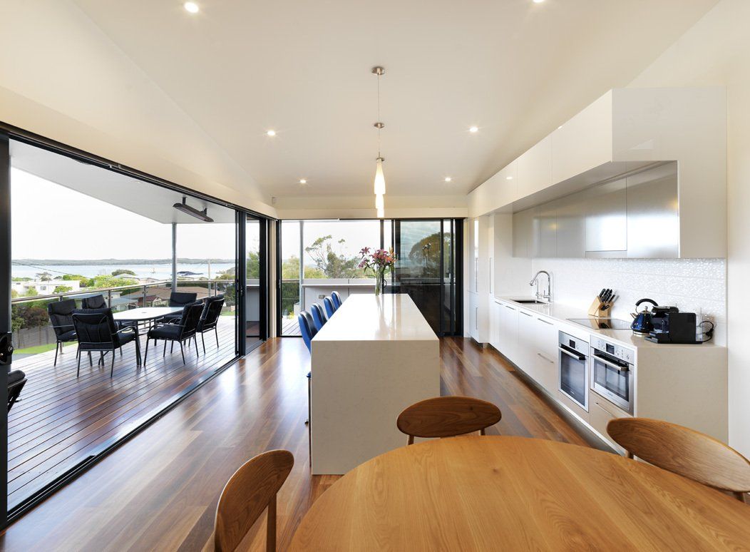 A kitchen with a table and chairs in it